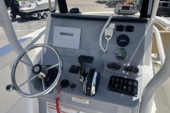 2023 Trophy T24 CC boat dashboard with steering wheel, controls, and Simrad display.