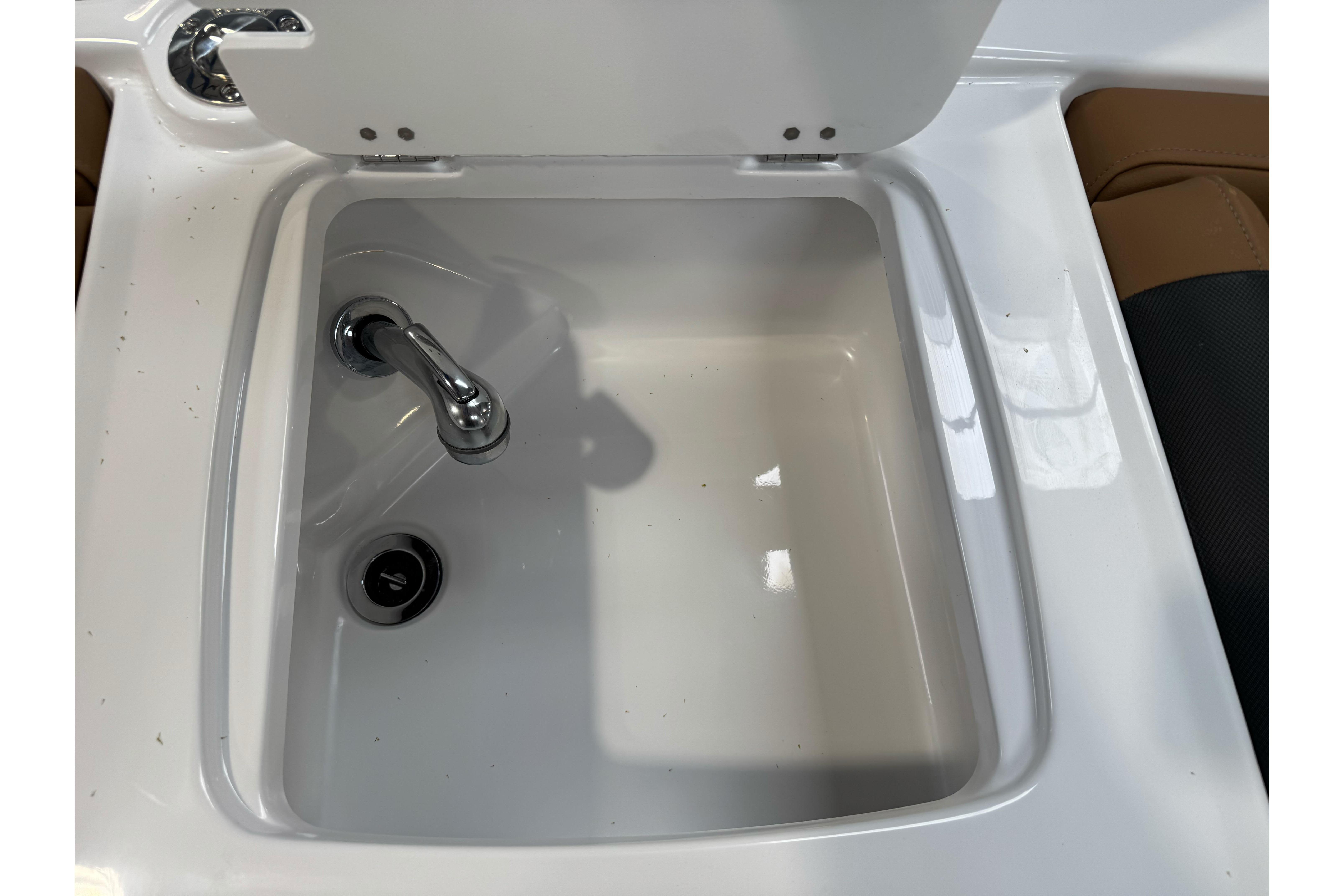 2026 Tahoe 2150 boat sink with chrome faucet and drain plug.