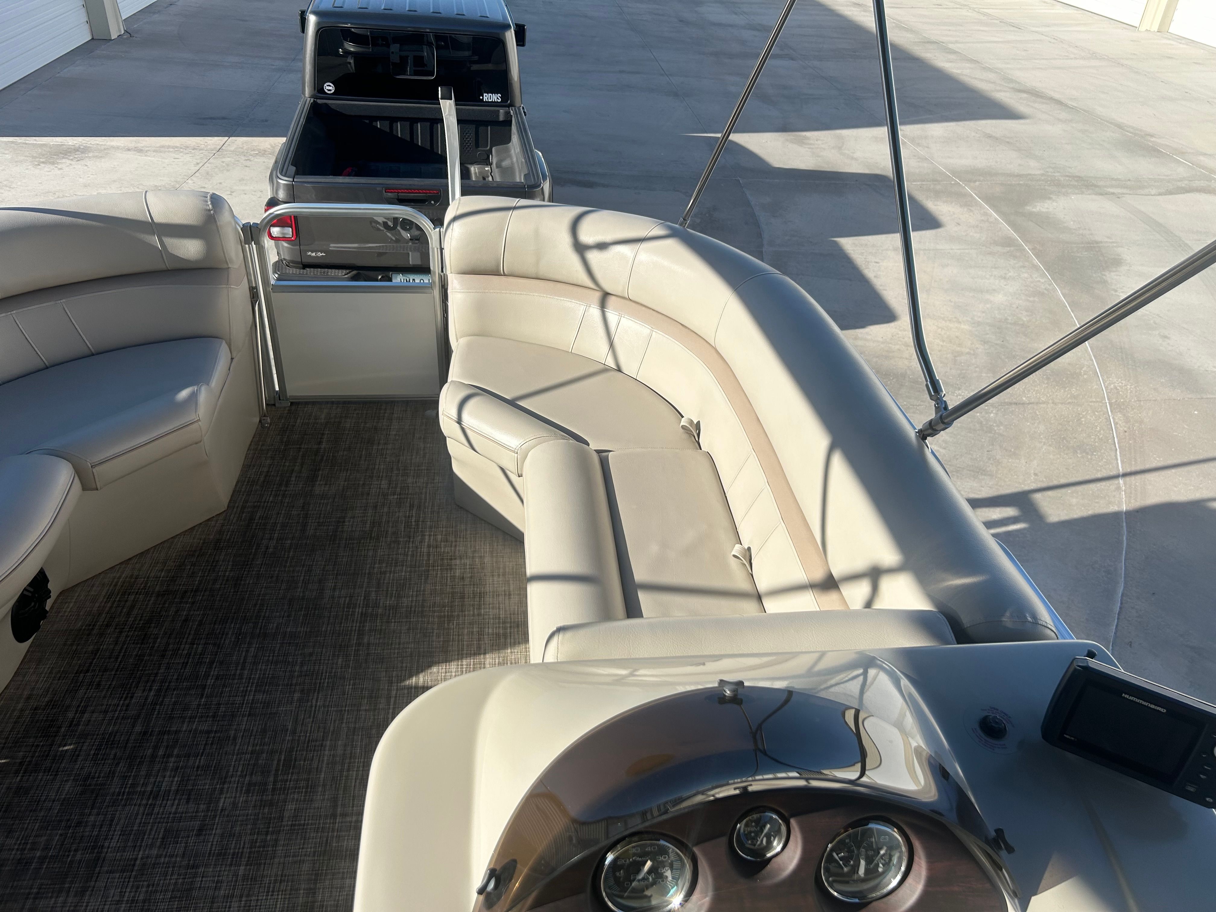 The image shows the interior of a 2018 Berkshire 24RFX CTS pontoon boat with beige seating.