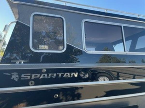 2025 Spartan 2600 Olympia boat with sleek black exterior and large windows.