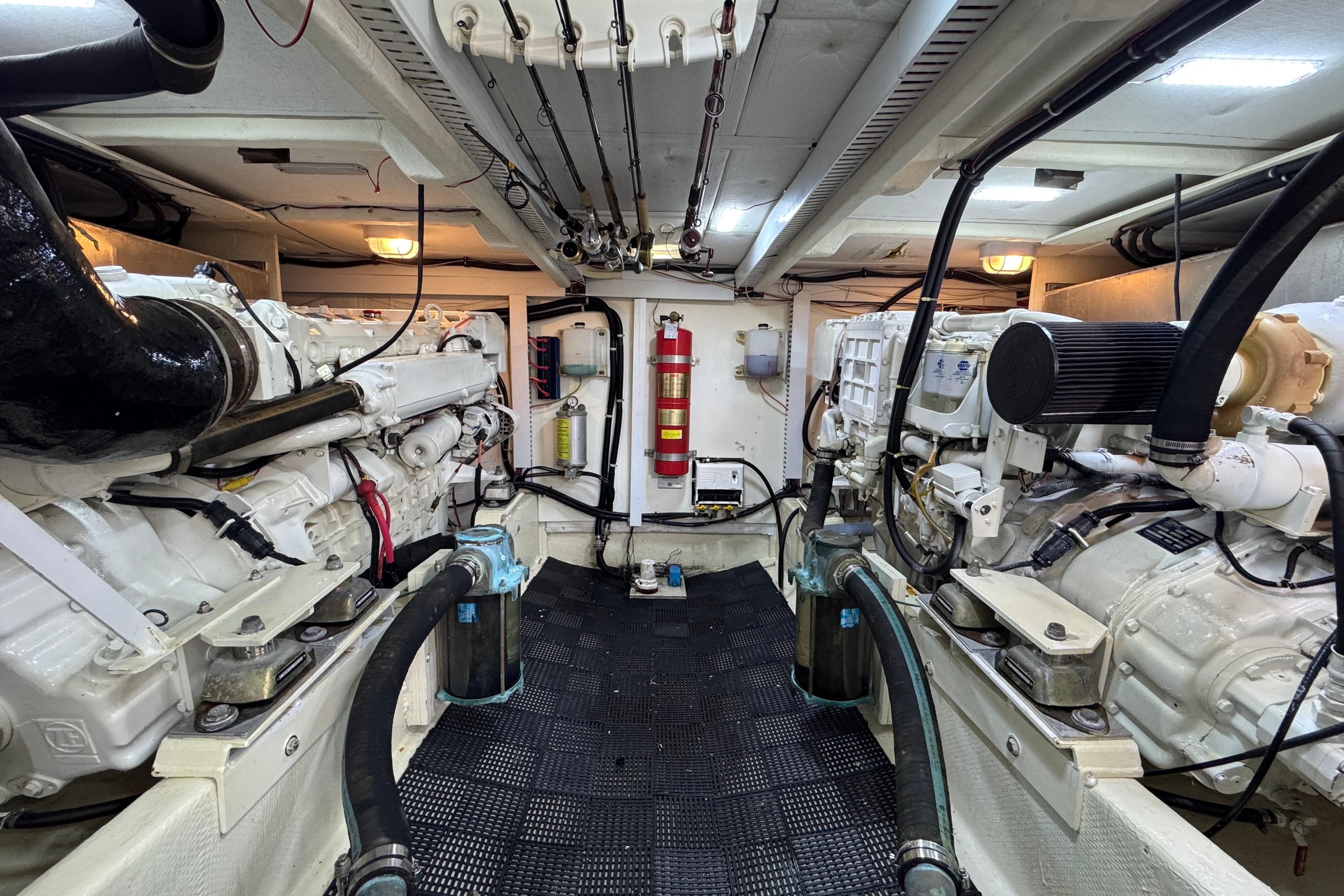 Engine room of 1998 Bayliner 5788 Pilot House Motoryacht, featuring dual engines and equipment.