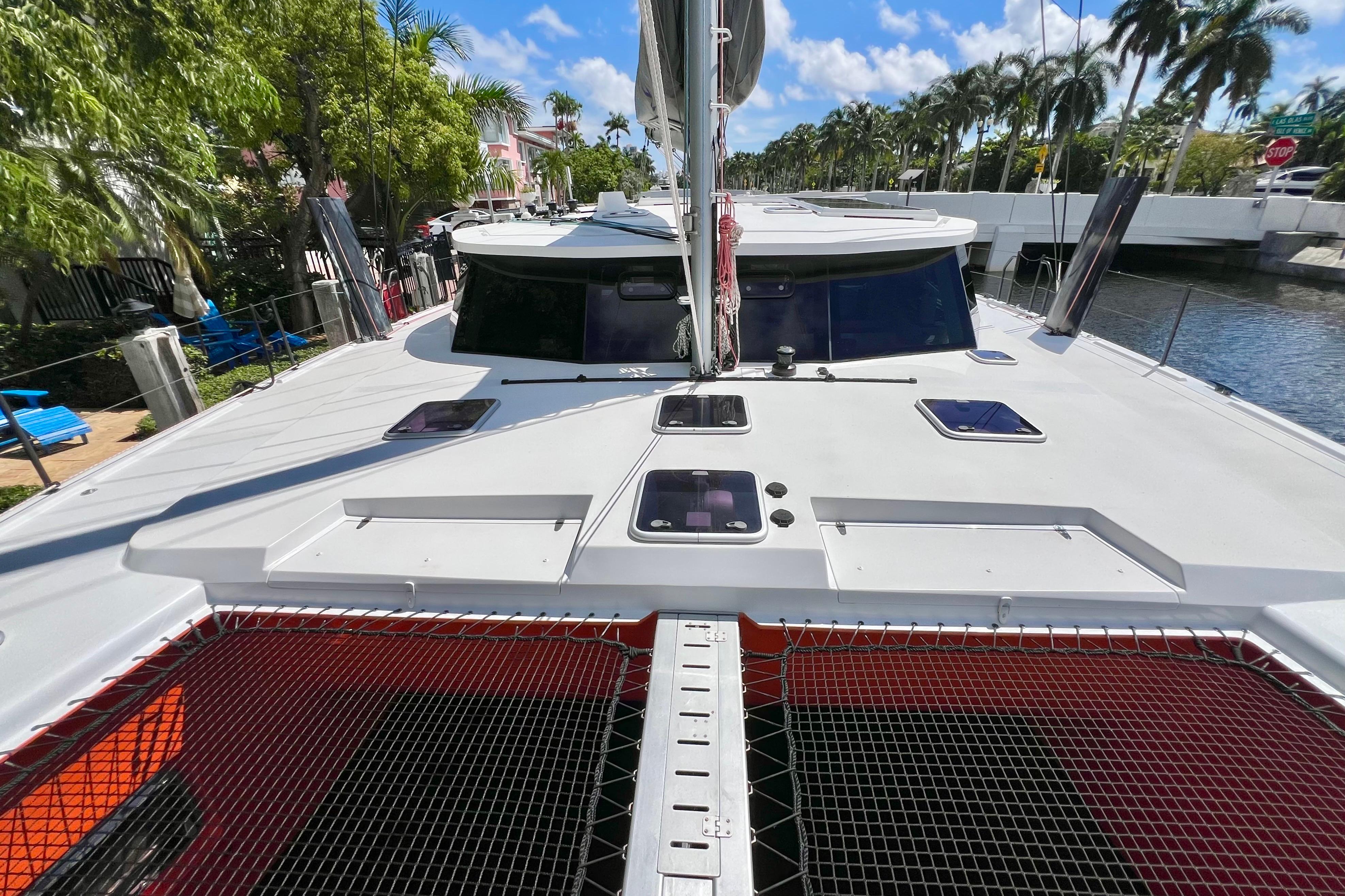 Catamaran Balance 482, 2021 model, docked in a tropical canal setting.