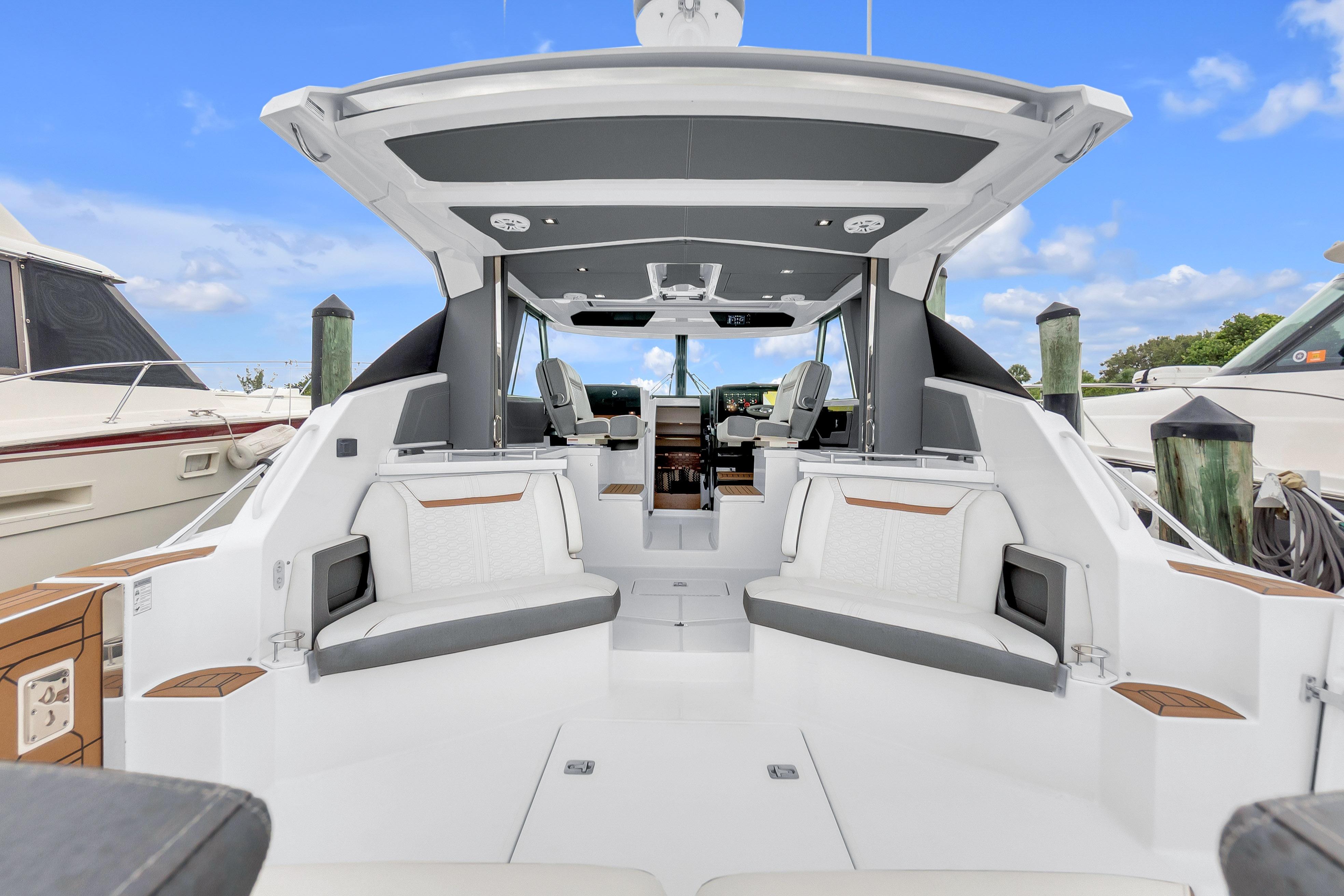2021 Tiara Sport 43 LE luxury boat interior with seating and helm, docked at marina.