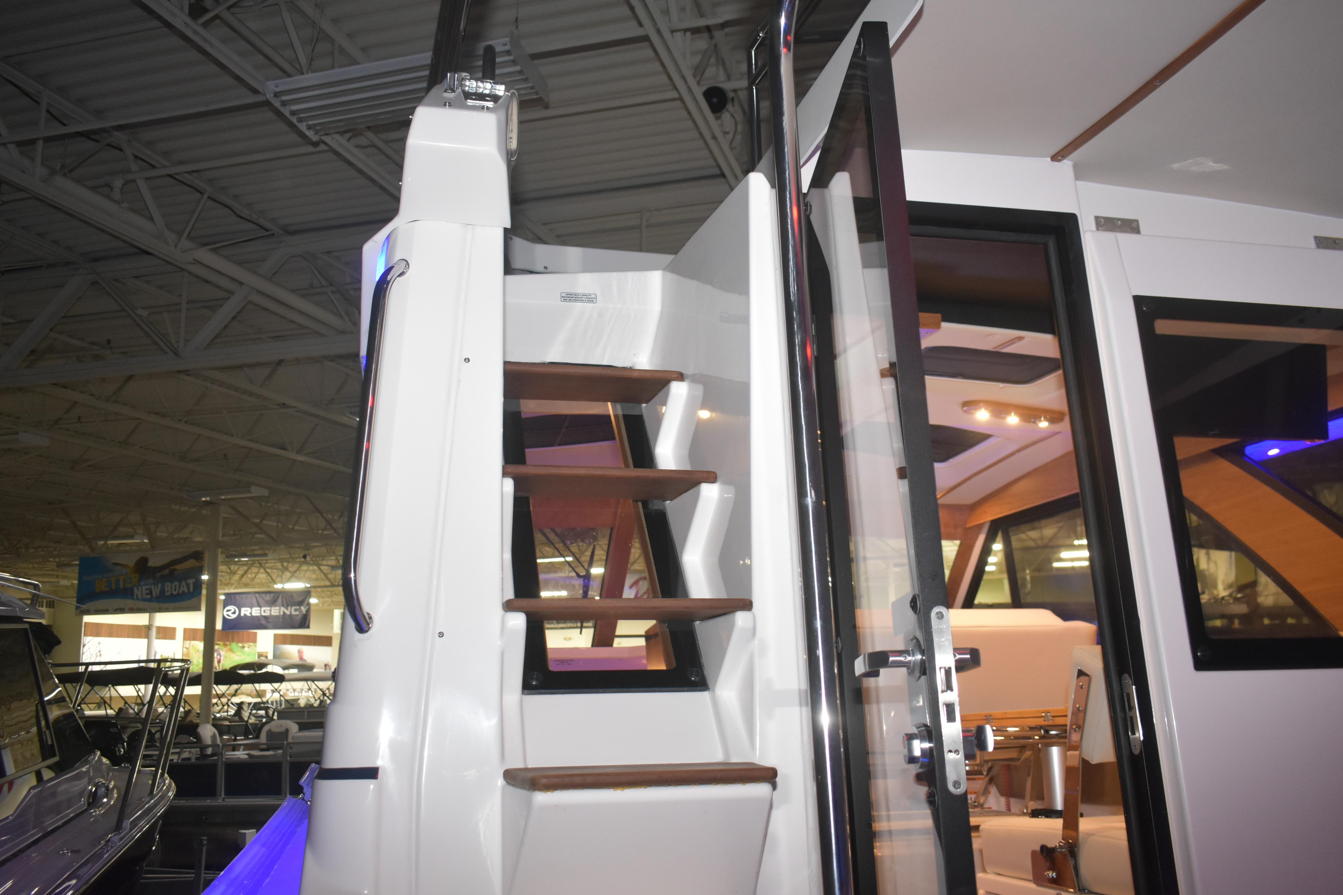 Staircase and interior view of 2026 Cutwater C-32 CB boat at an indoor showroom.