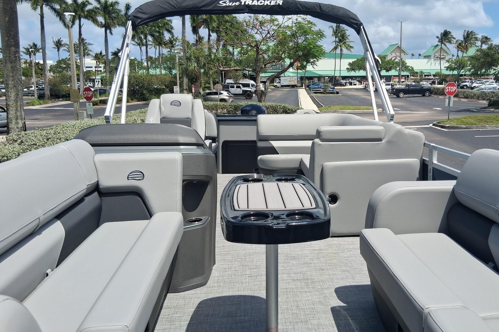 2026 Sun Tracker SportFish 22 DLX pontoon boat with spacious seating and table.