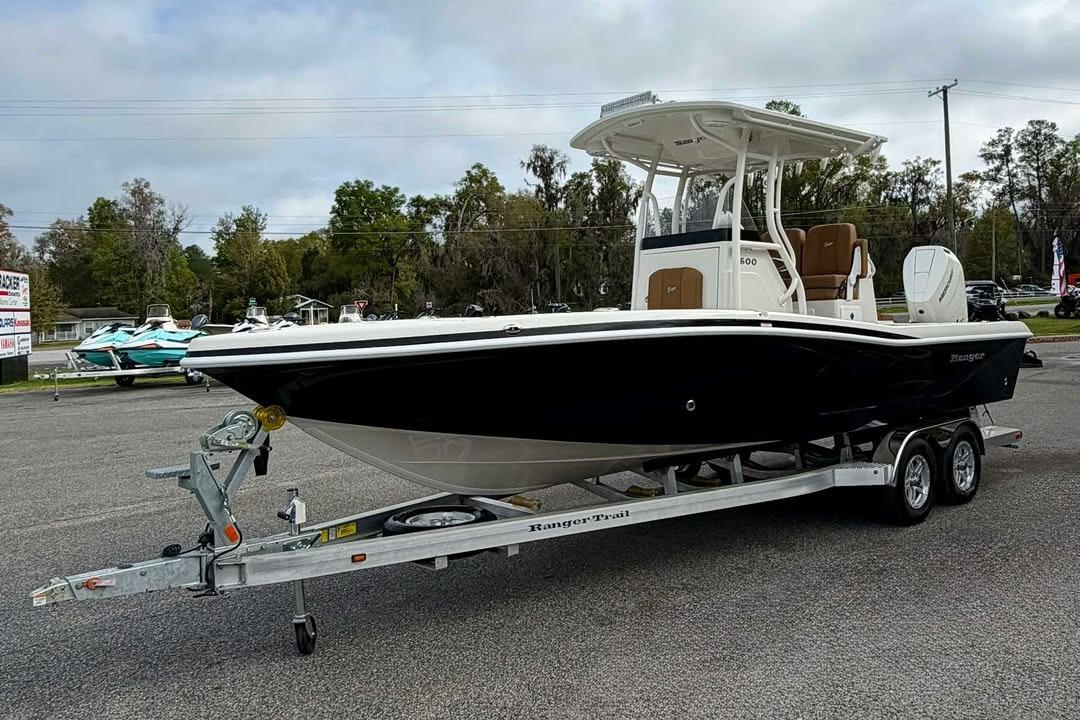 2026 Ranger 2600 Bay boat on trailer, parked outdoors, showcasing sleek design and modern features.