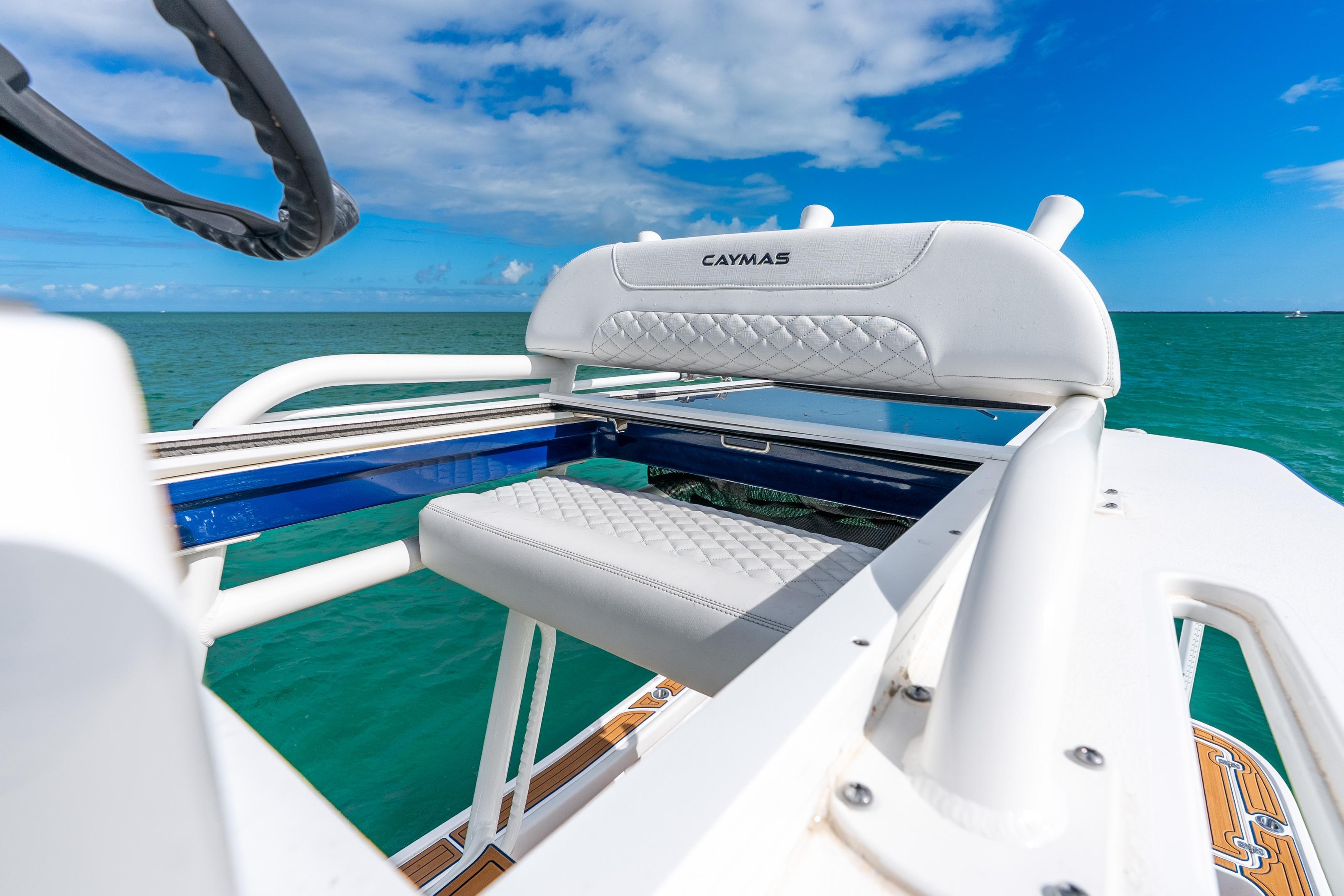 2024 Caymas 281 HB boat with white seating, ocean view, and blue sky.