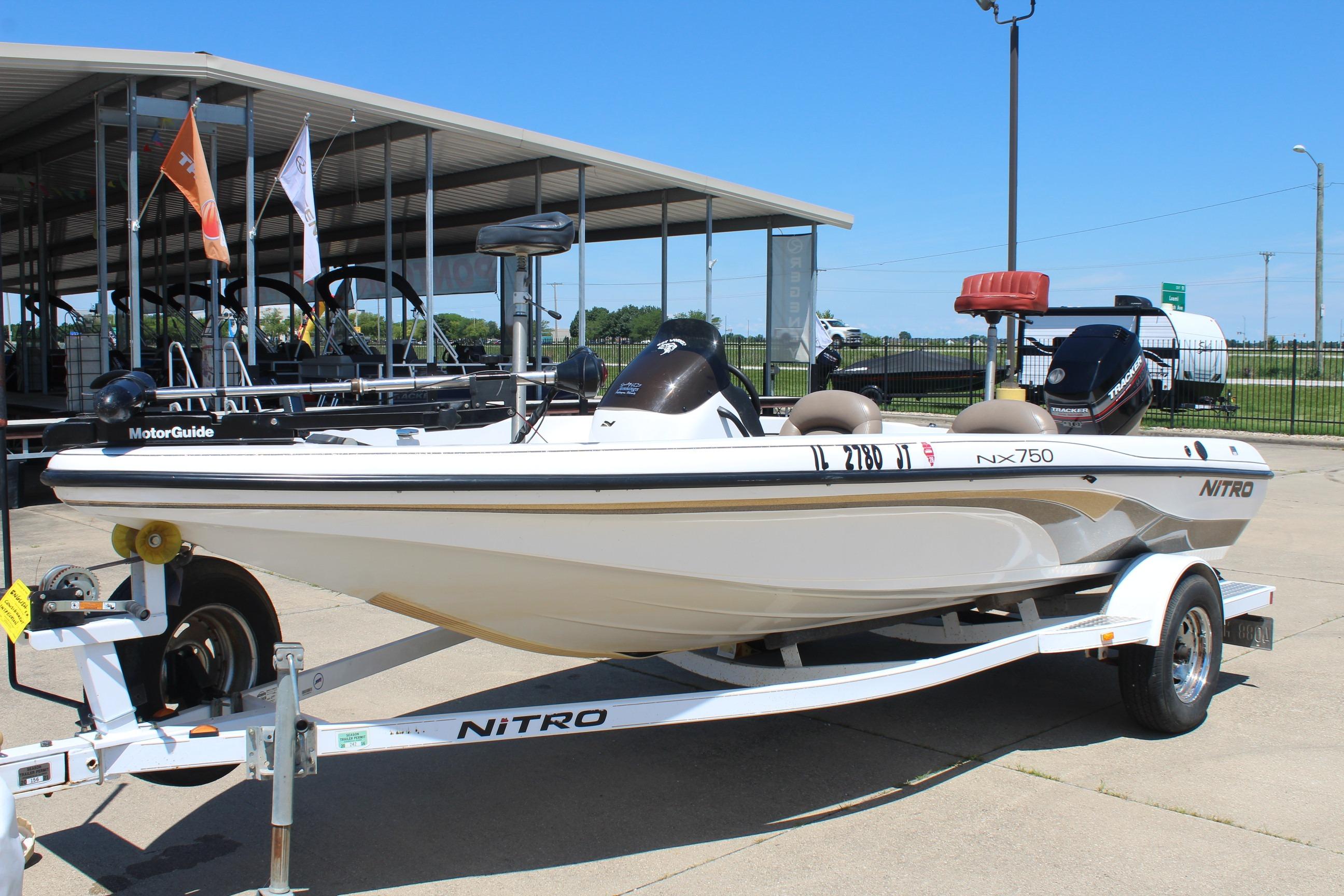 2003 Nitro NX 750 SC fishing boat on trailer at dealership.