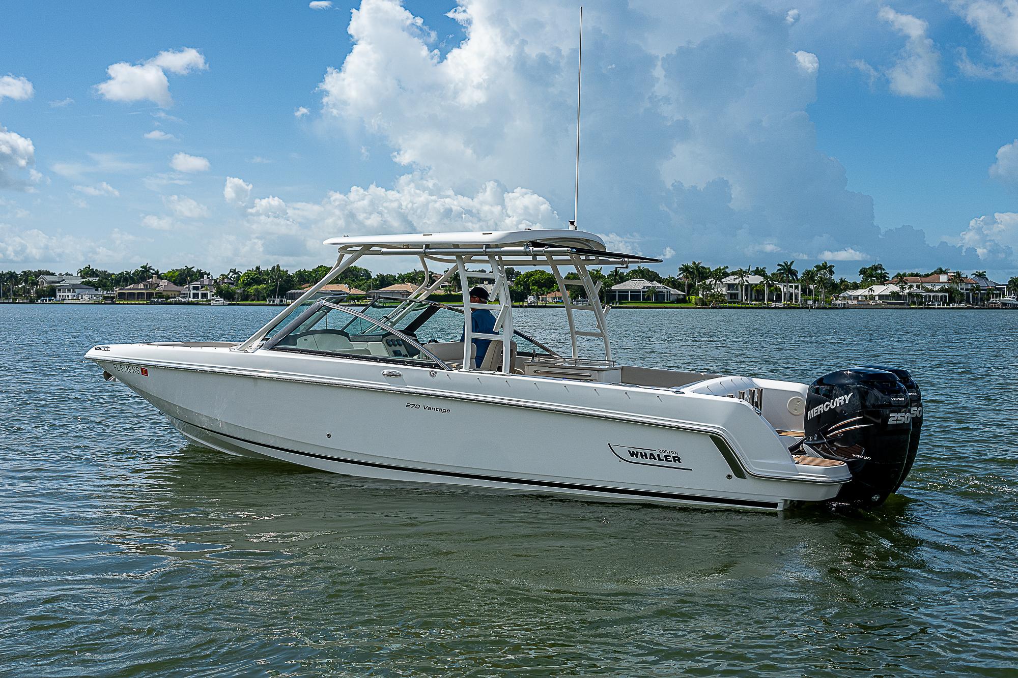 2018 Boston Whaler 270 Vantage boat on calm water under a blue sky.