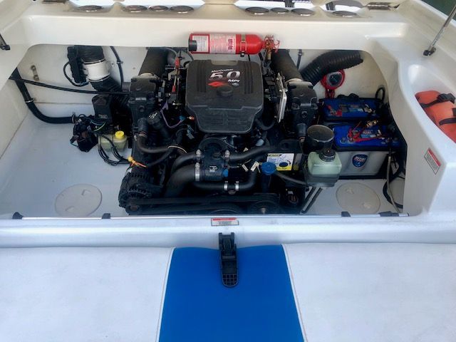 Engine compartment of a 2003 Baja 20 Outlaw with a clean engine and accessories.