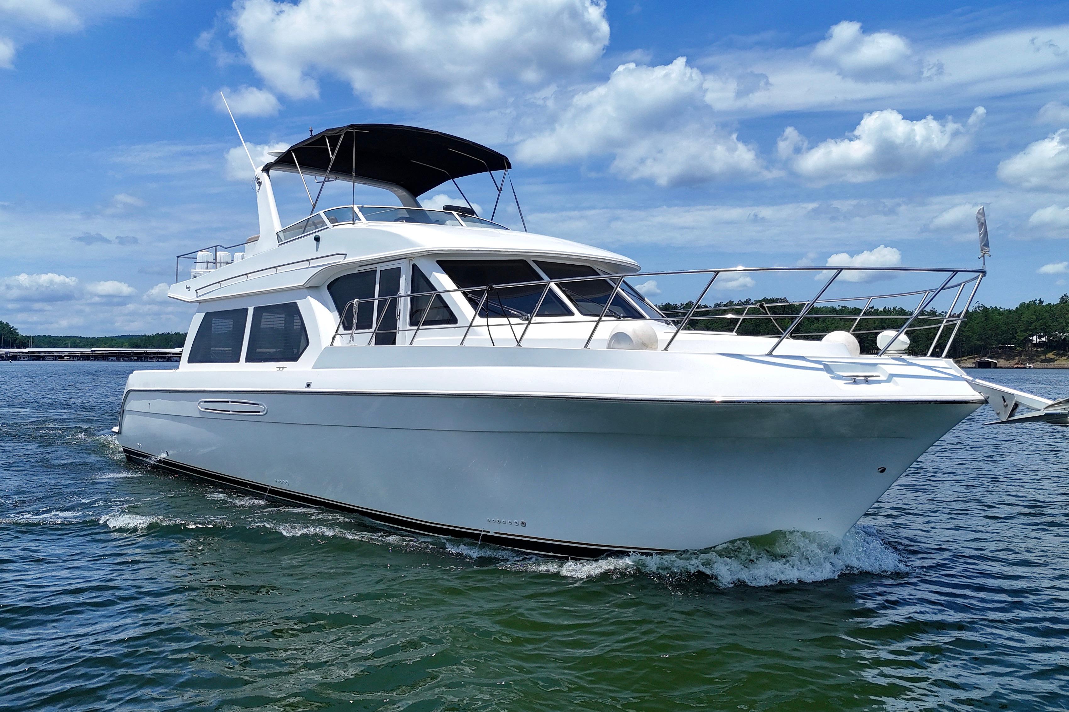 Luxury 2007 Navigator 5100 yacht cruising on a sunny day with blue skies.