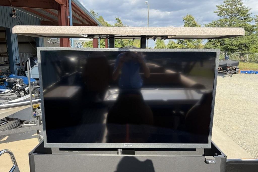 Outdoor TV setup on Premier 250 Solaris RS CL, 2026 model, under a canopy.