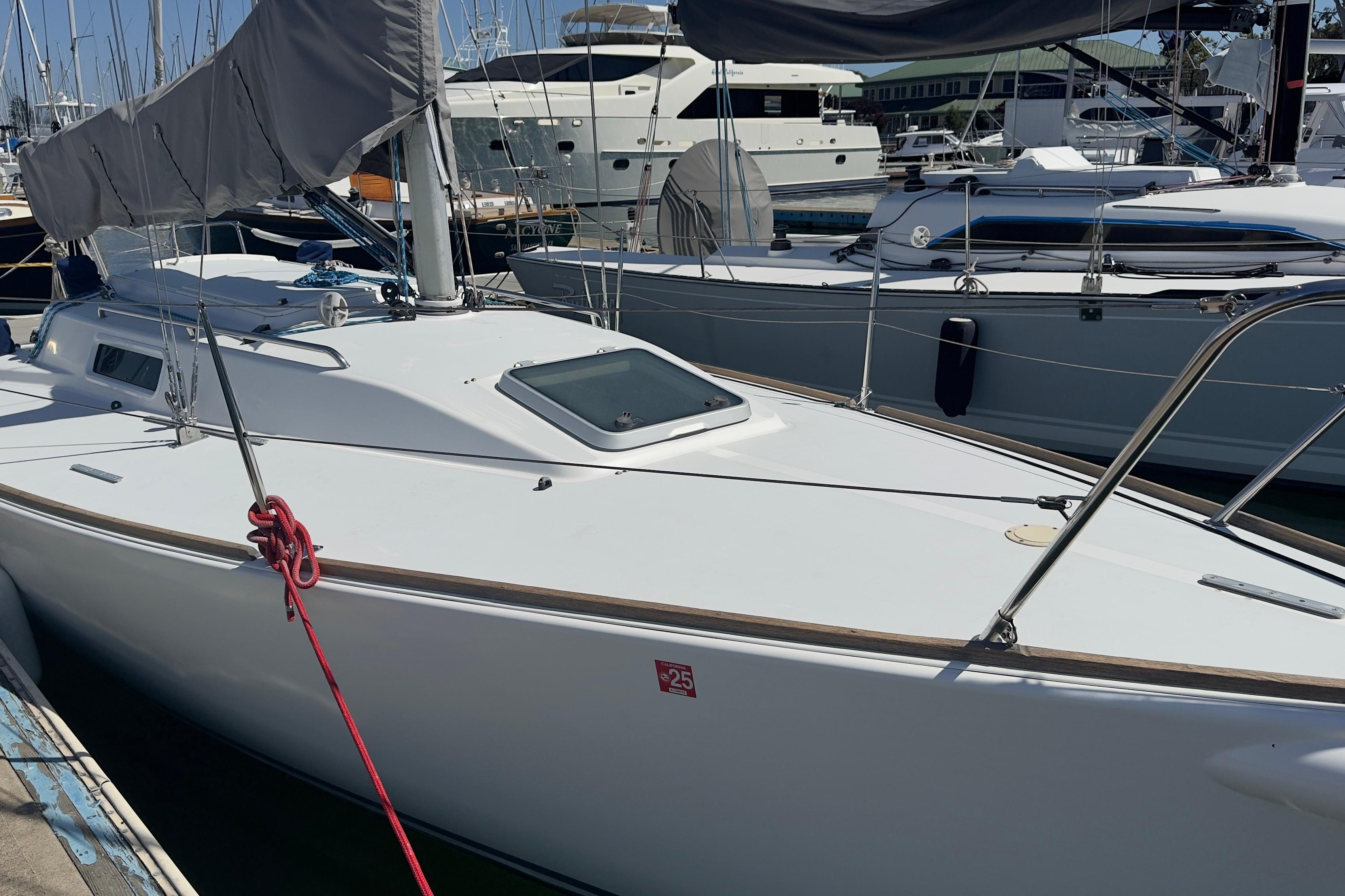 1994 J Boats J/92 sailboat docked in a marina, featuring sleek white design.
