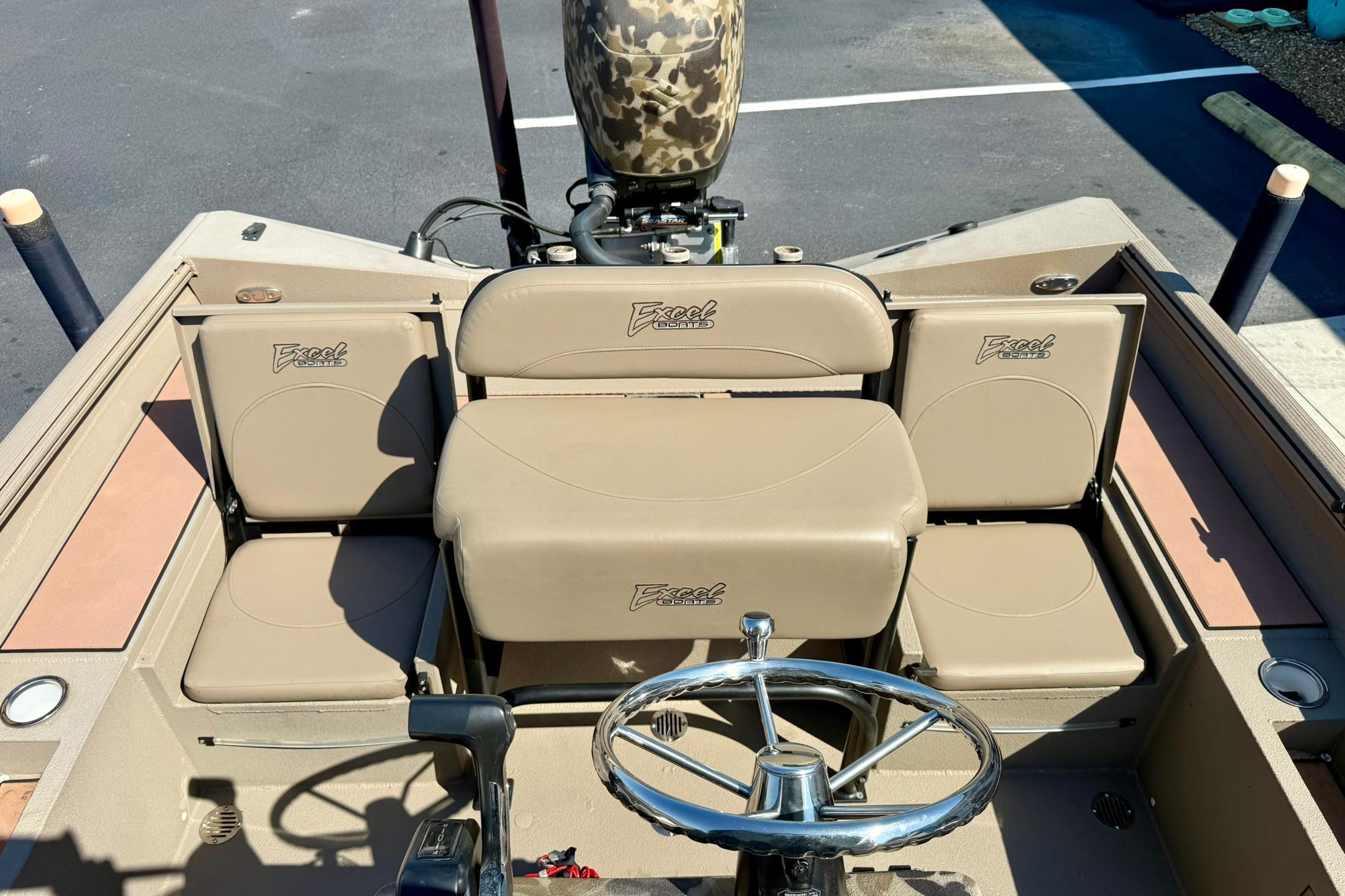 2019 Excel 230 Bay Pro boat interior with beige seating and steering wheel.