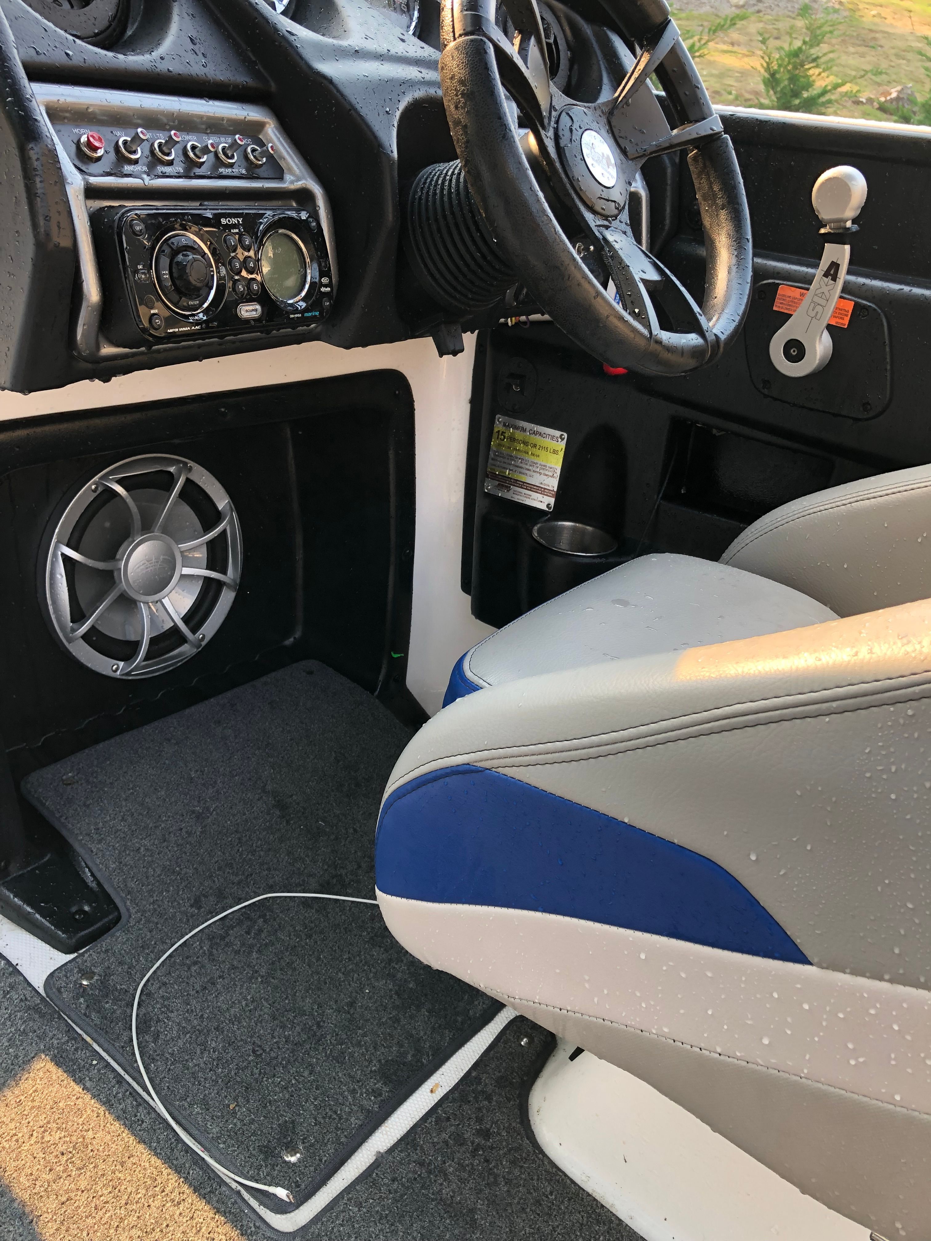 Interior of a 2015 Custom a22 boat with steering wheel and control console.