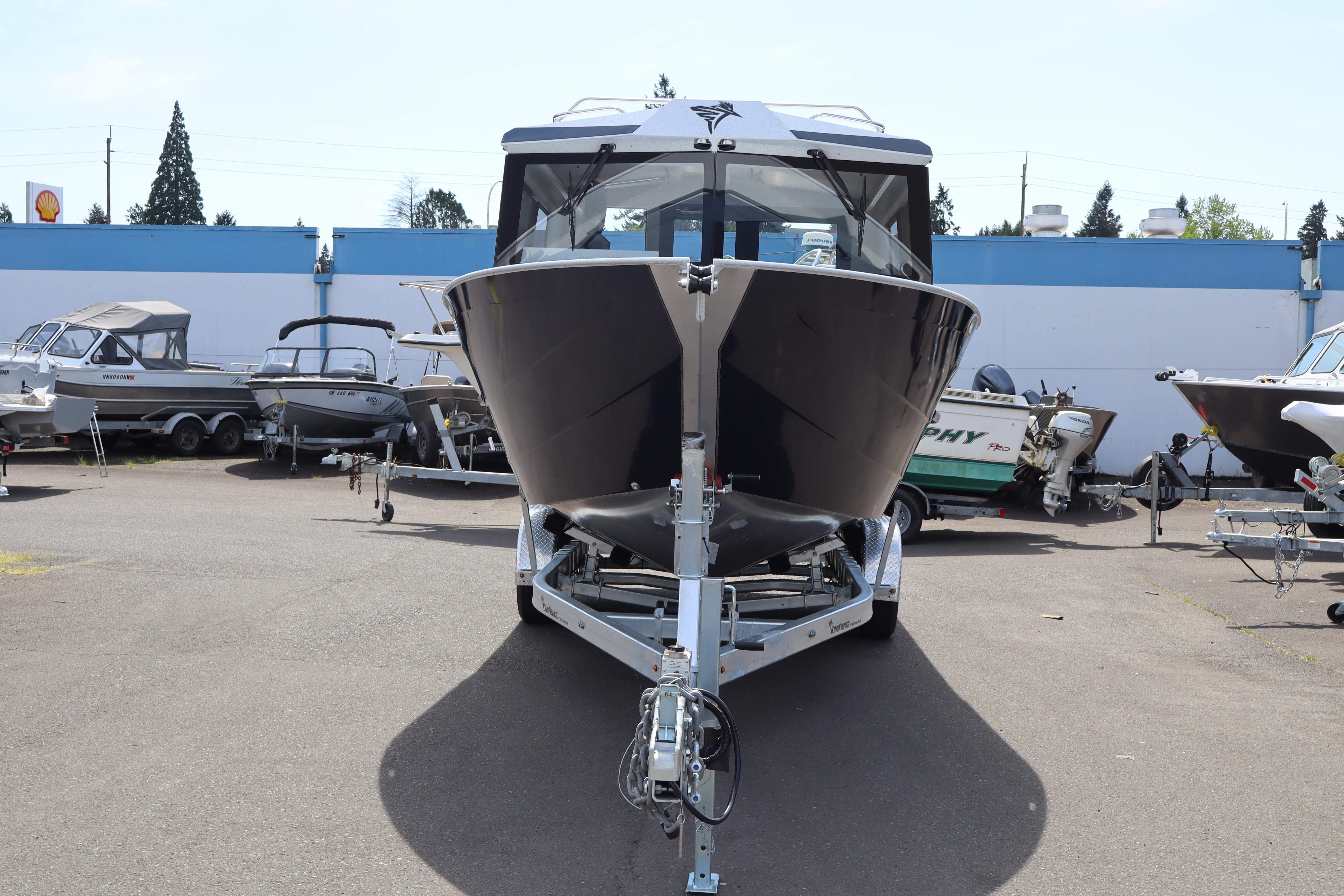 2026 KingFisher 25 XAC boat on trailer in outdoor showroom.