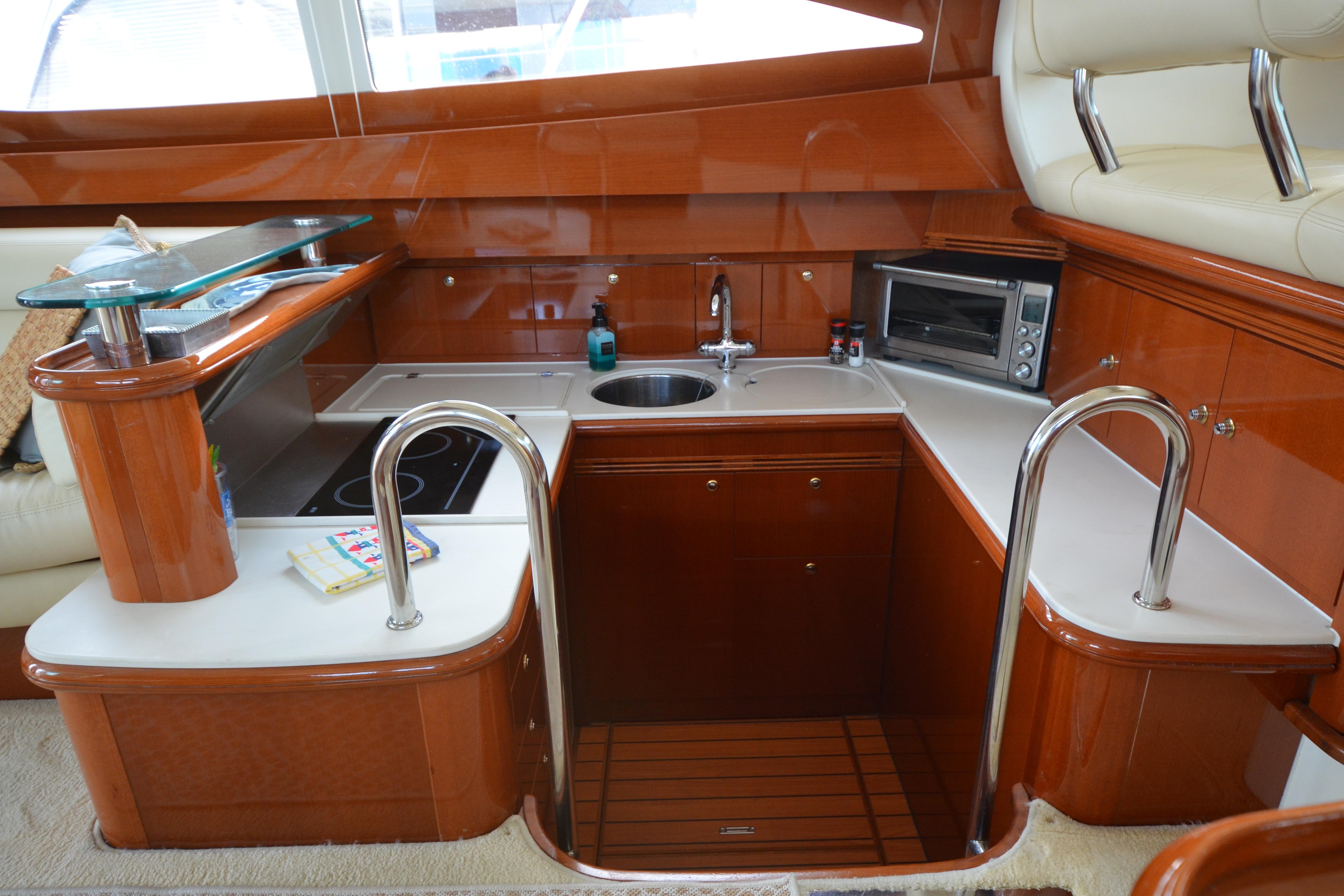 Luxurious kitchen interior of 2007 Jeanneau Prestige 46 yacht with modern amenities.
