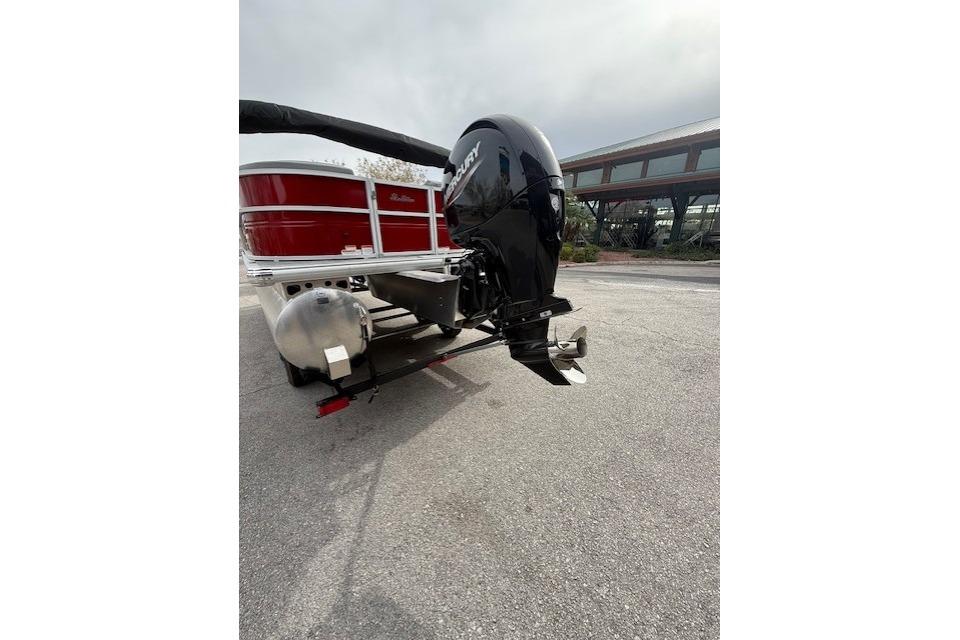 2026 Sun Tracker Party Barge 22 DLX with Mercury outboard motor on a trailer.