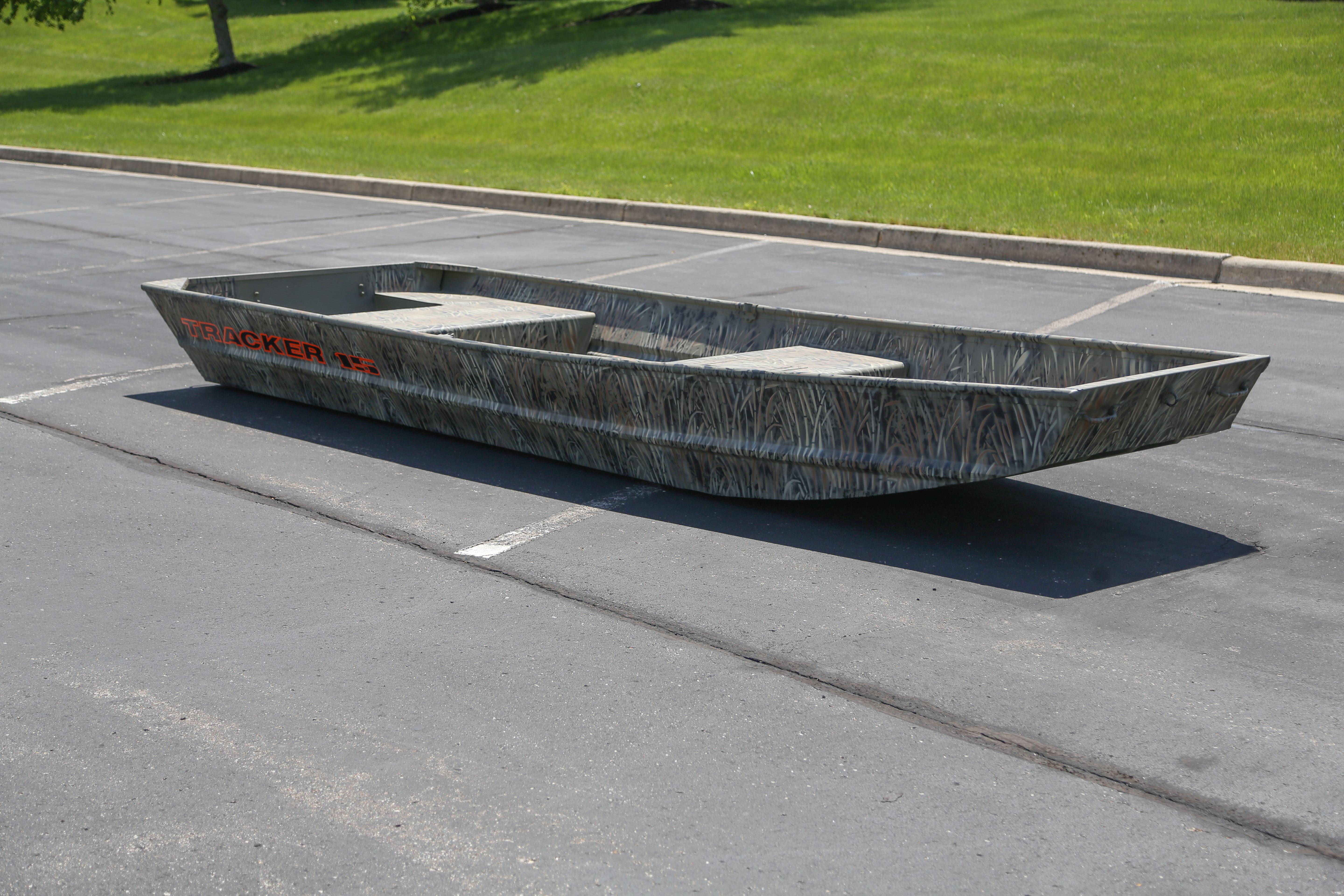 2026 Tracker Grizzly 15 Jon boat parked on asphalt, showcasing its rugged design.