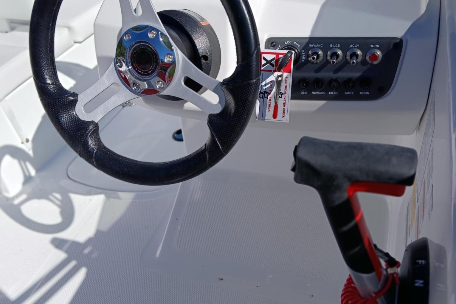 Steering wheel and control panel of 2026 Tahoe T16 boat cockpit.