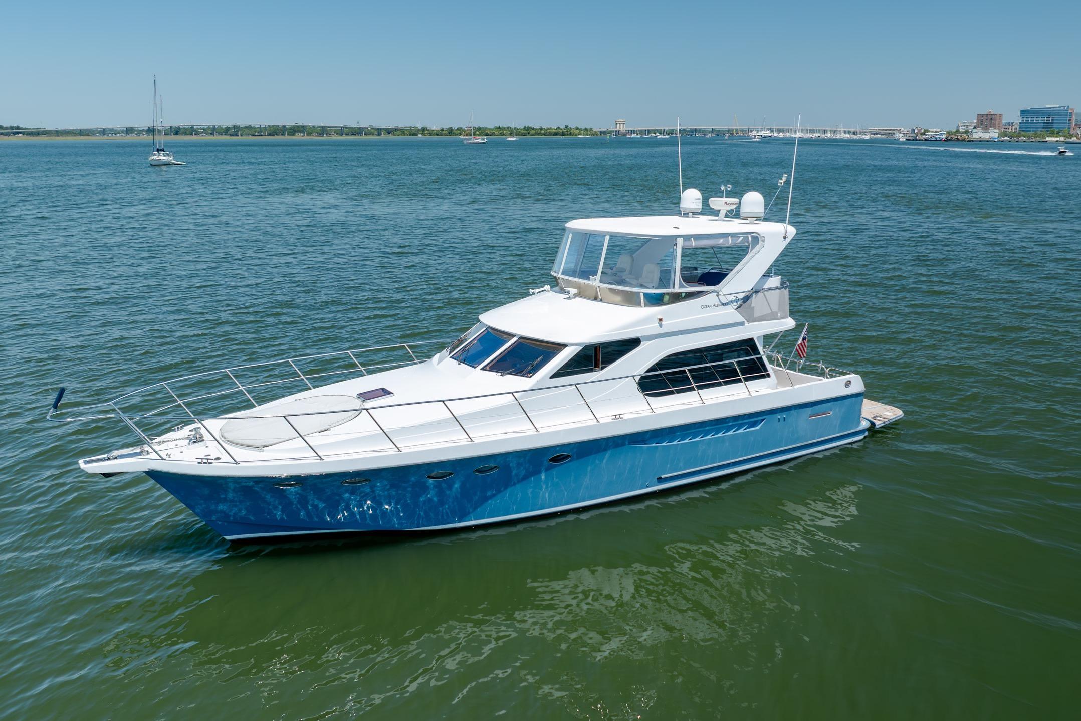 Luxurious Ocean Alexander yacht cruising on calm waters under a clear blue sky.