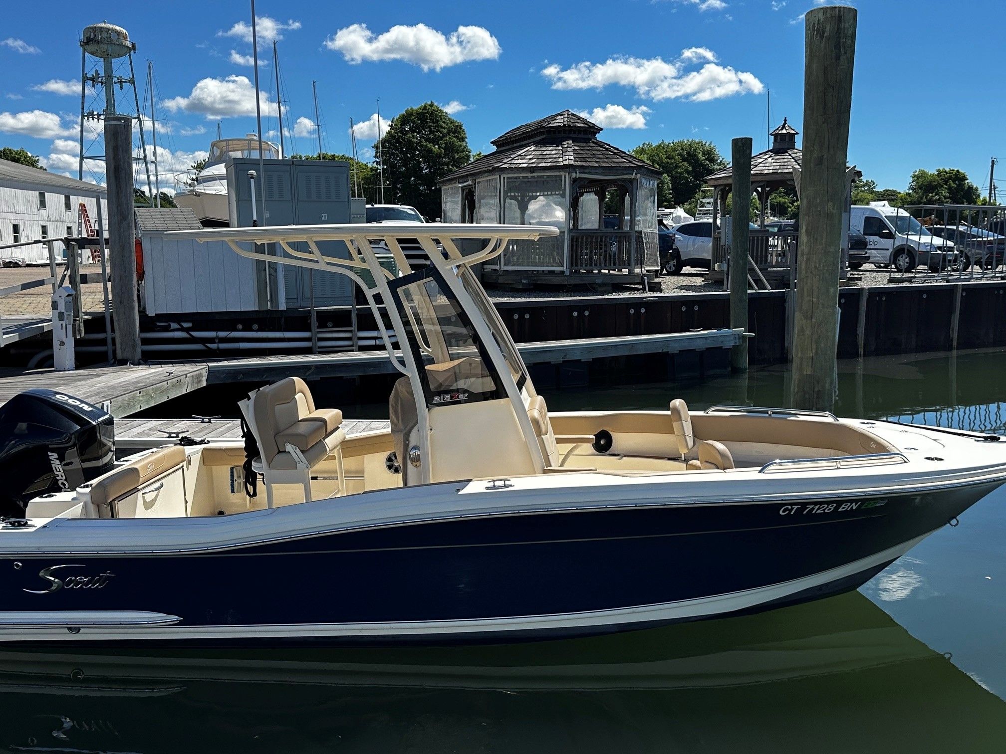 Scout 210XSF boat 2022 docked at harbor on a sunny day.