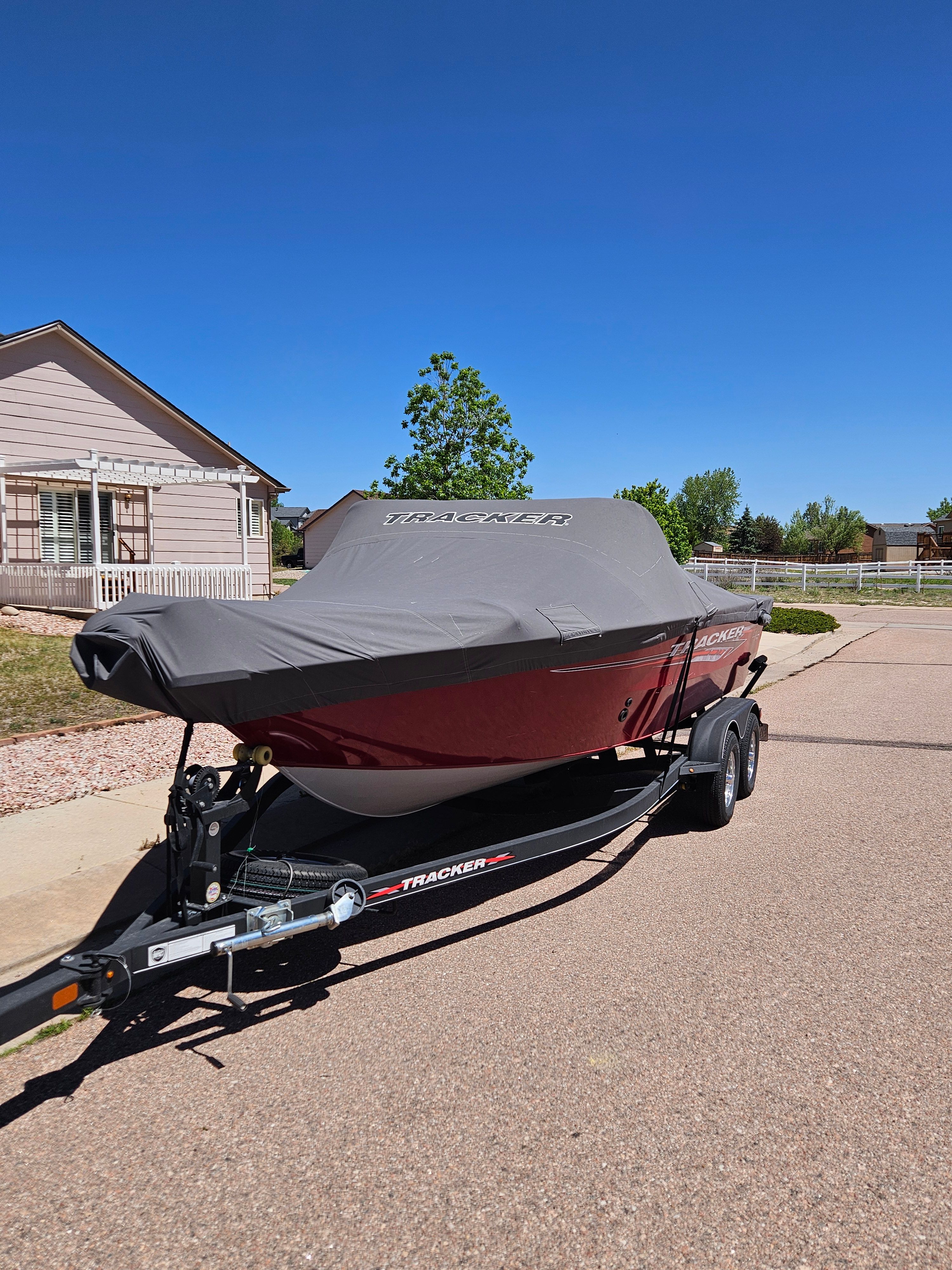 2021 Tracker Pro Guide V-175 WT boat on trailer in residential area.