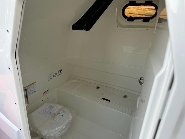 Interior of 2025 Brig Eagle 8 boat, featuring a compact bathroom with a toilet.