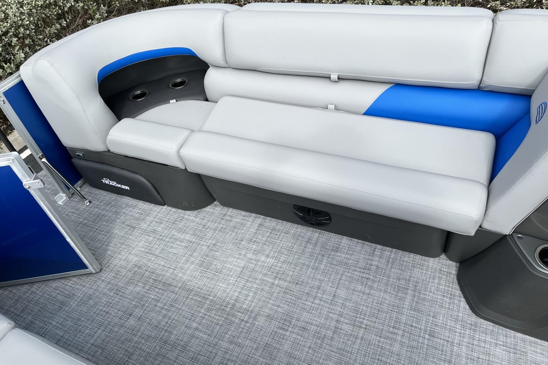 2026 Sun Tracker Party Barge 20 DLX interior with gray and blue seating.