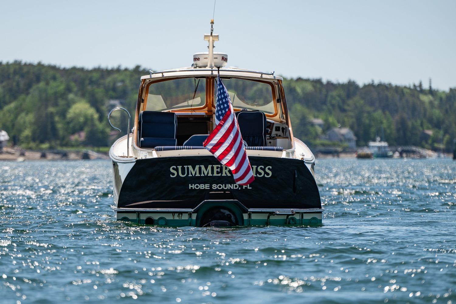 Hinckley Picnic Boat 36 Classic, 2001, on water with American flag, scenic background.