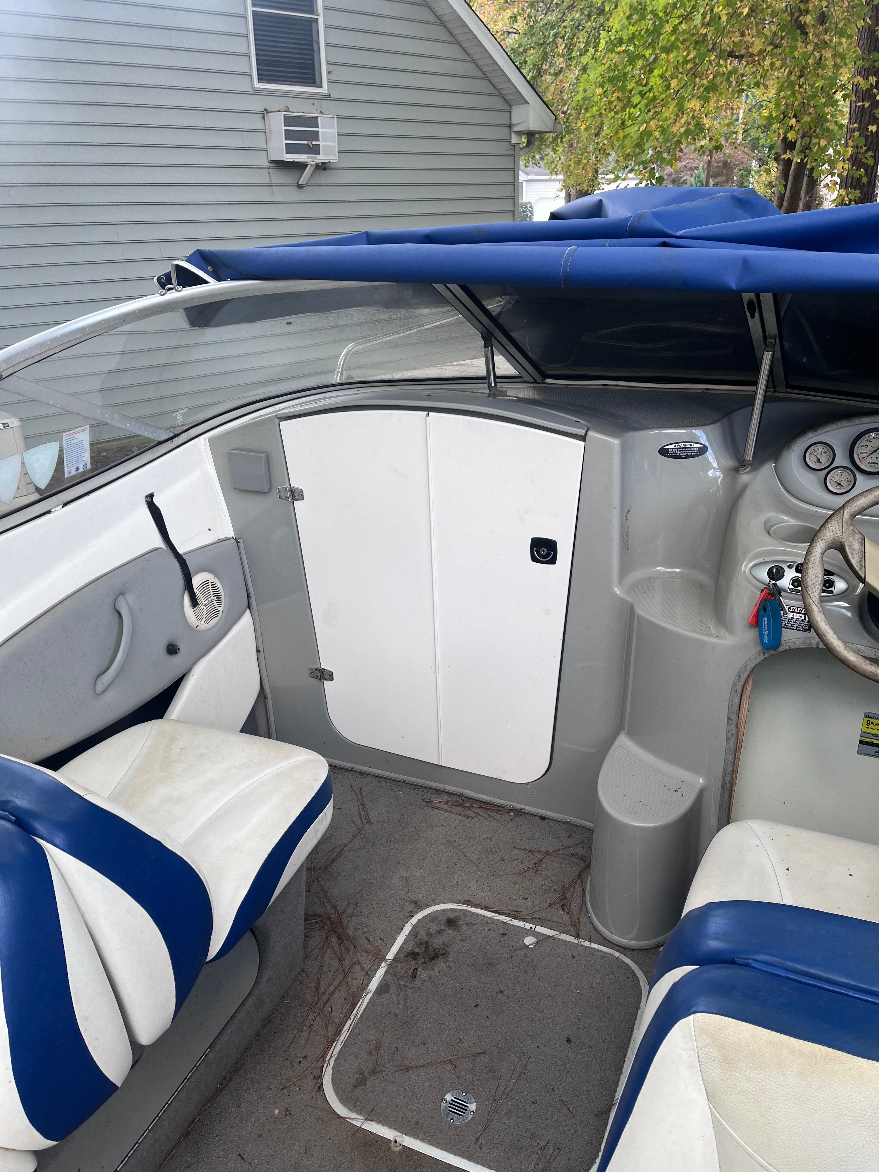 Interior of a 2005 Bayliner Cuddy Capri boat with blue and white seats.