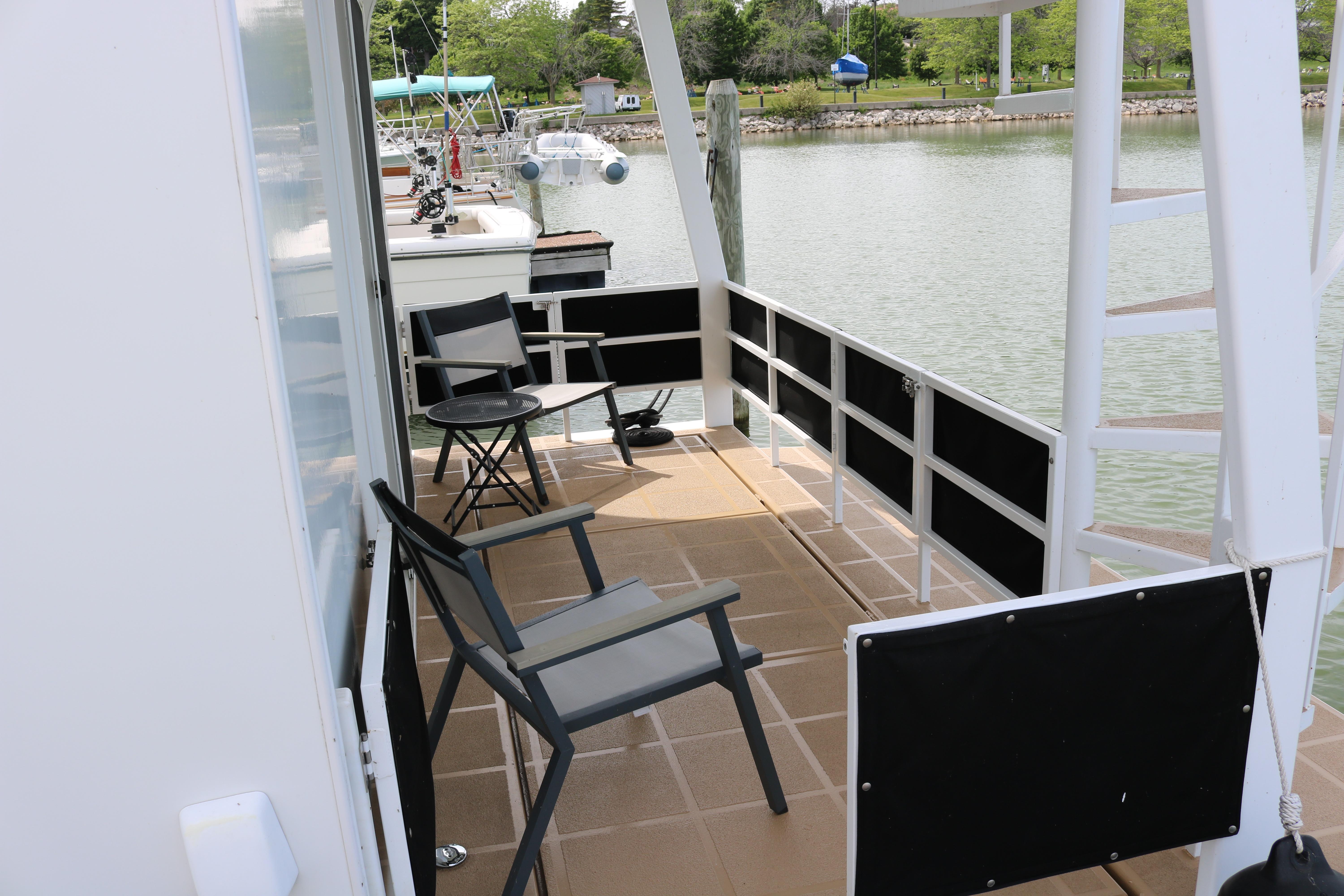 Skipperliner 480 Flybridge 2010 boat deck with chairs overlooking serene water.