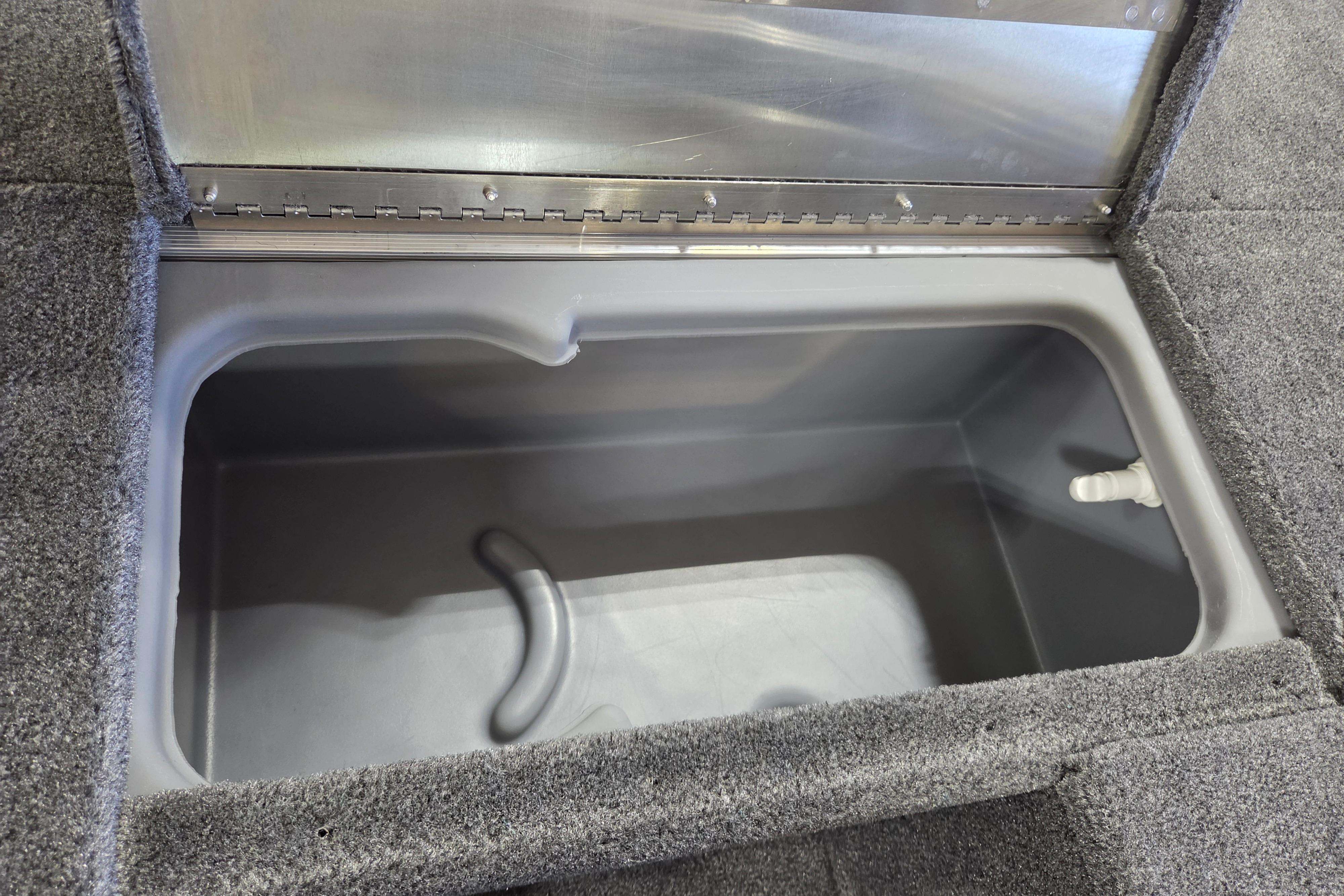 Open storage compartment in 2026 Tracker Pro 170 boat, featuring gray interior and carpeted edges.