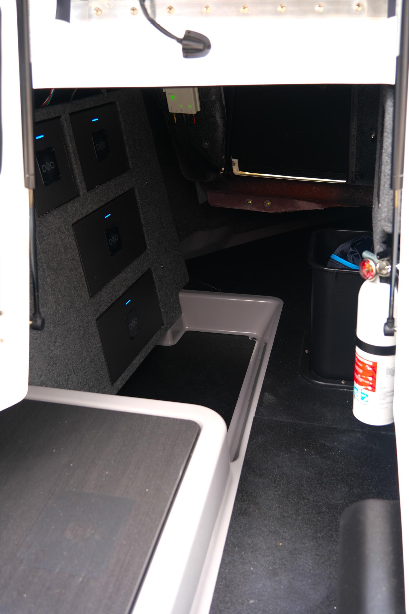 Interior of 2025 Supra SE450 boat with storage compartments and safety equipment.