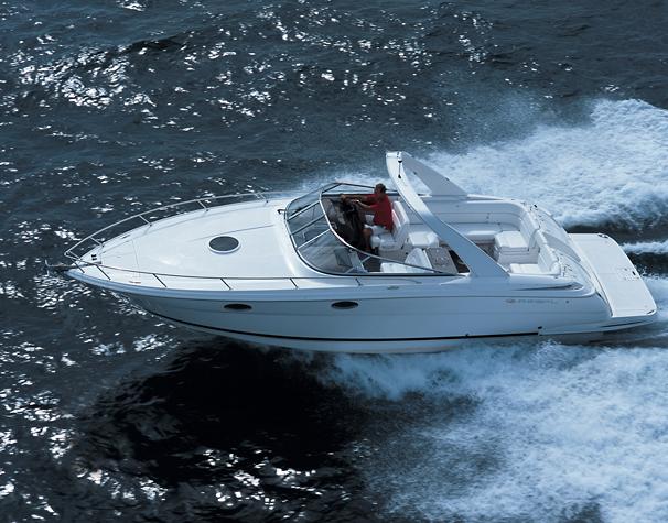 Manufacturer / Sistership Image Freshwater 2007 Regal 3350 Sport Cruiser docked at a marina, featuring sleek black and white design.