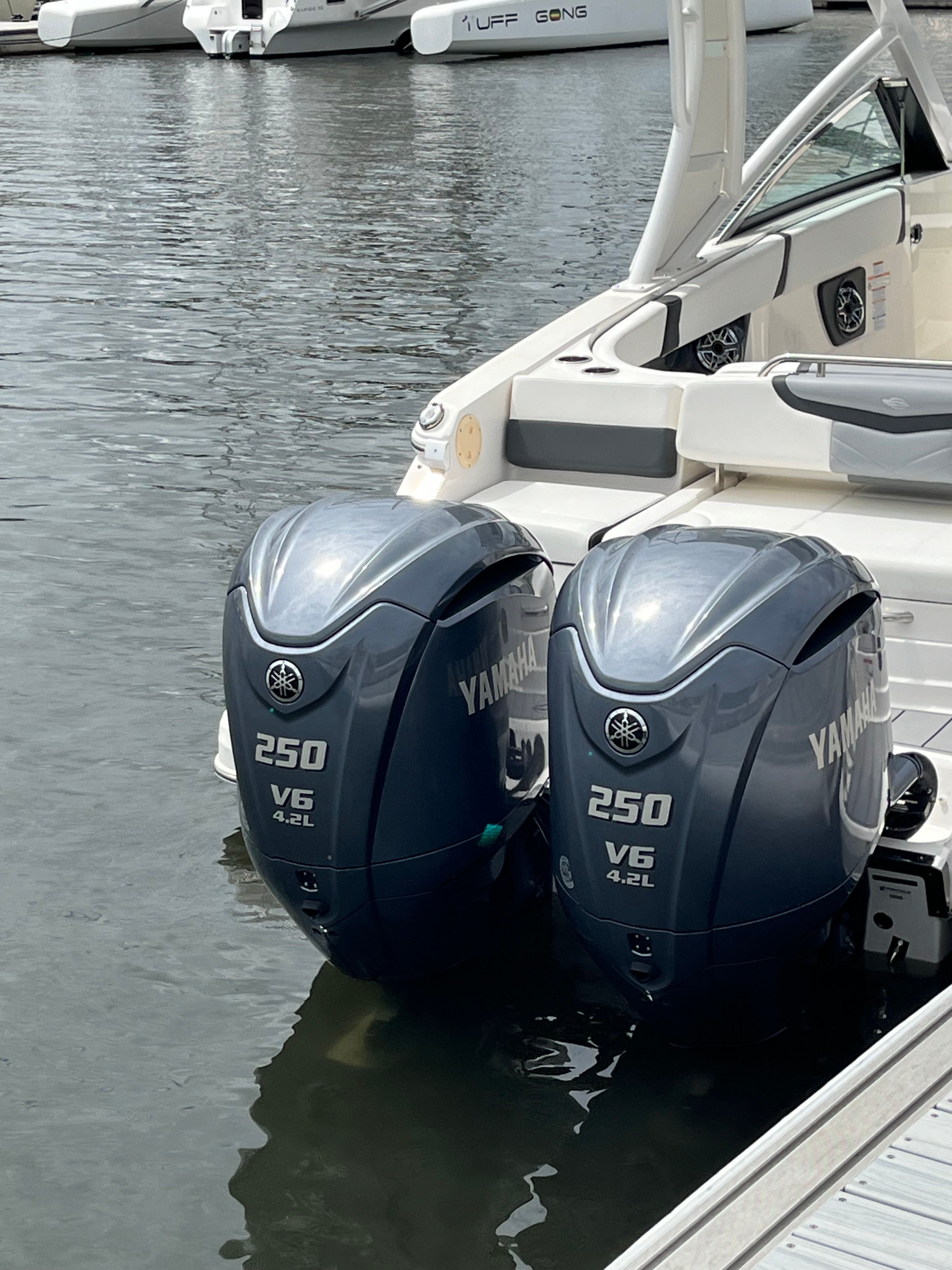 Two Yamaha 250 V6 outboard engines on a Chaparral 28 OSX boat in the water.