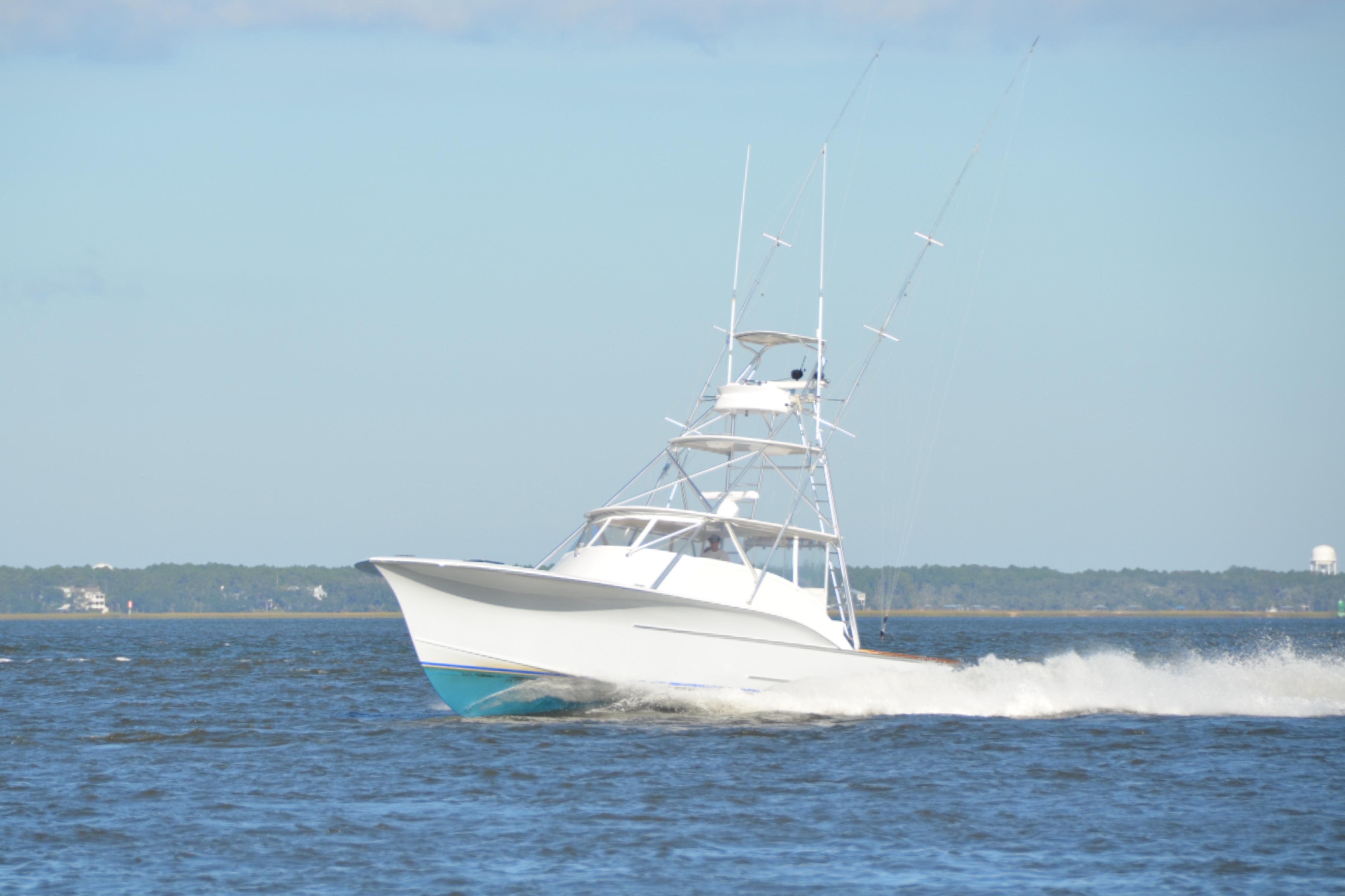 2006 Custom Carolina Heritage Express boat cruising on open water.