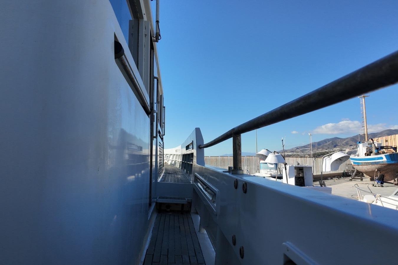 Side view of 2006 Custom Ocean Explorer 78 yacht in a shipyard.