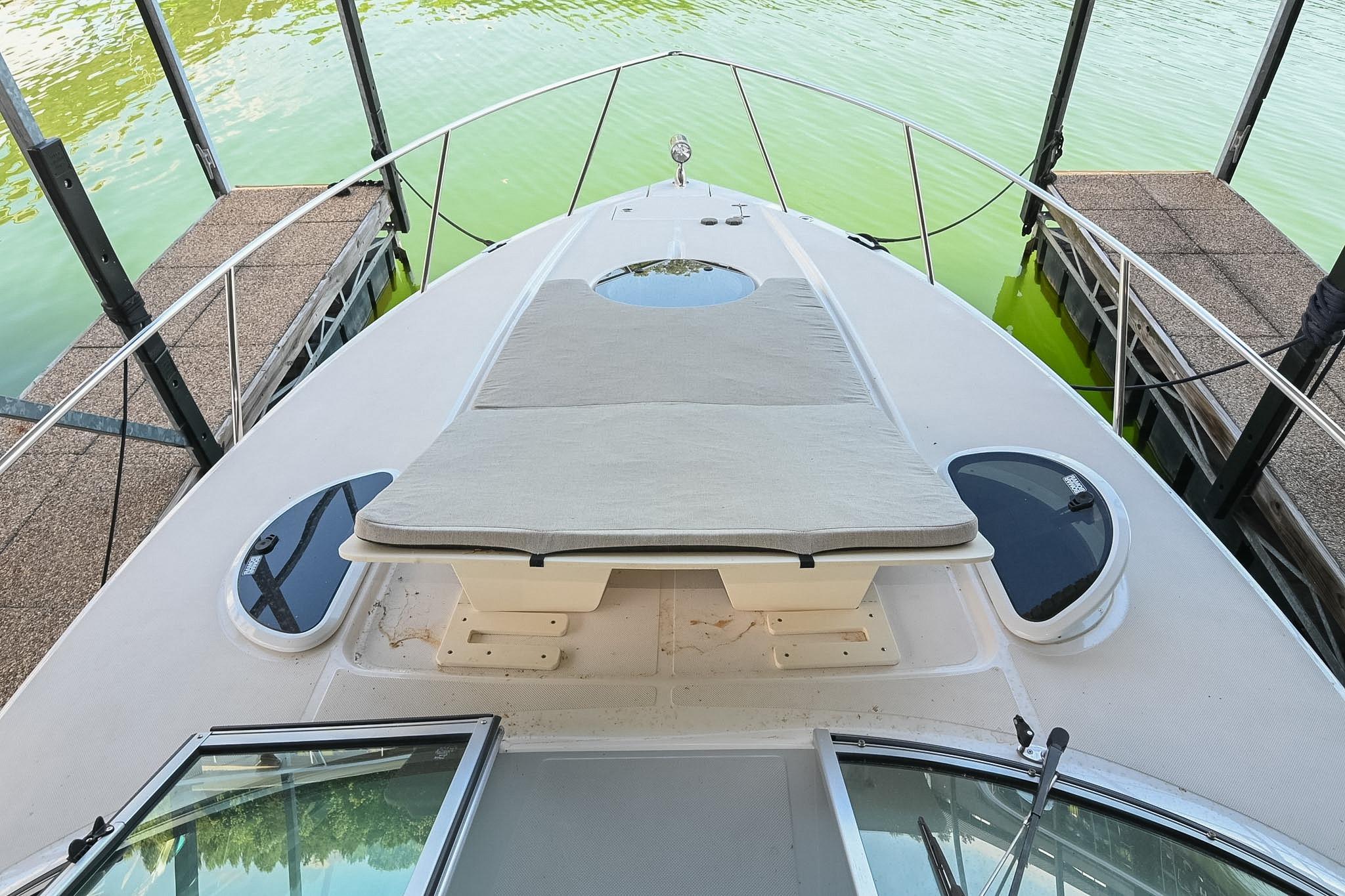2021 Regal 33 Express boat docked, featuring a spacious deck with sunbed.