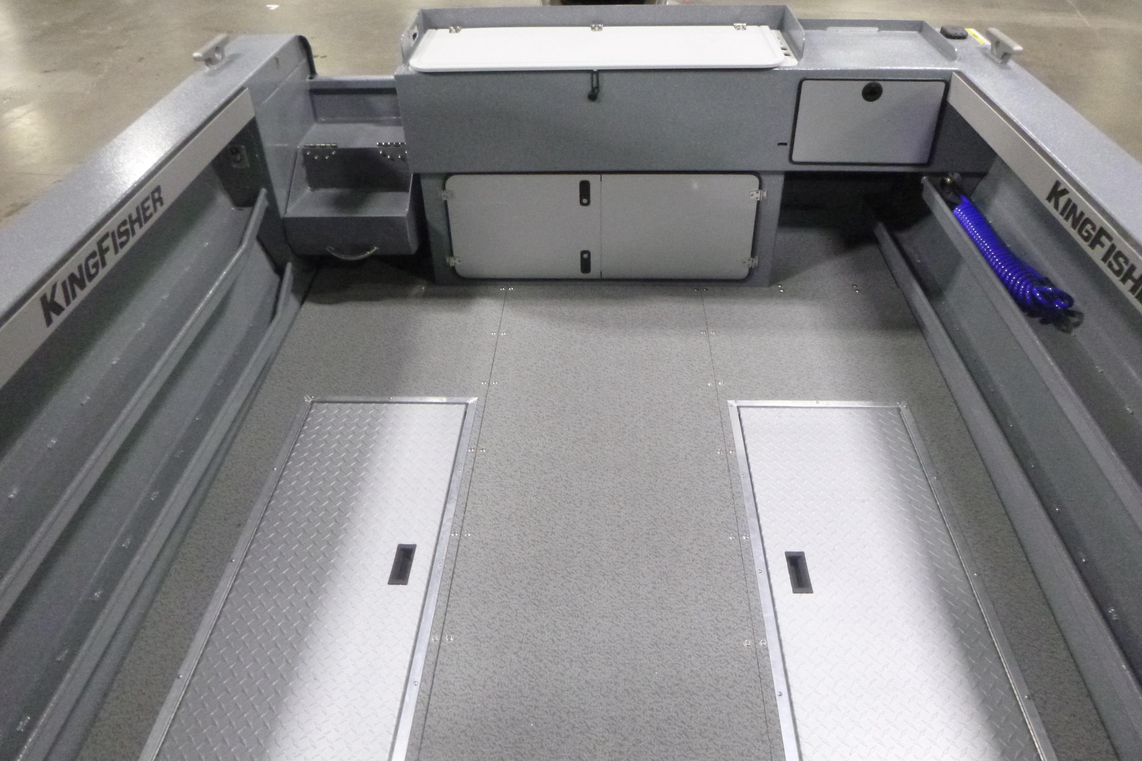 Interior of 2026 KingFisher 2425 Escape HT boat, featuring storage compartments and non-slip flooring.
