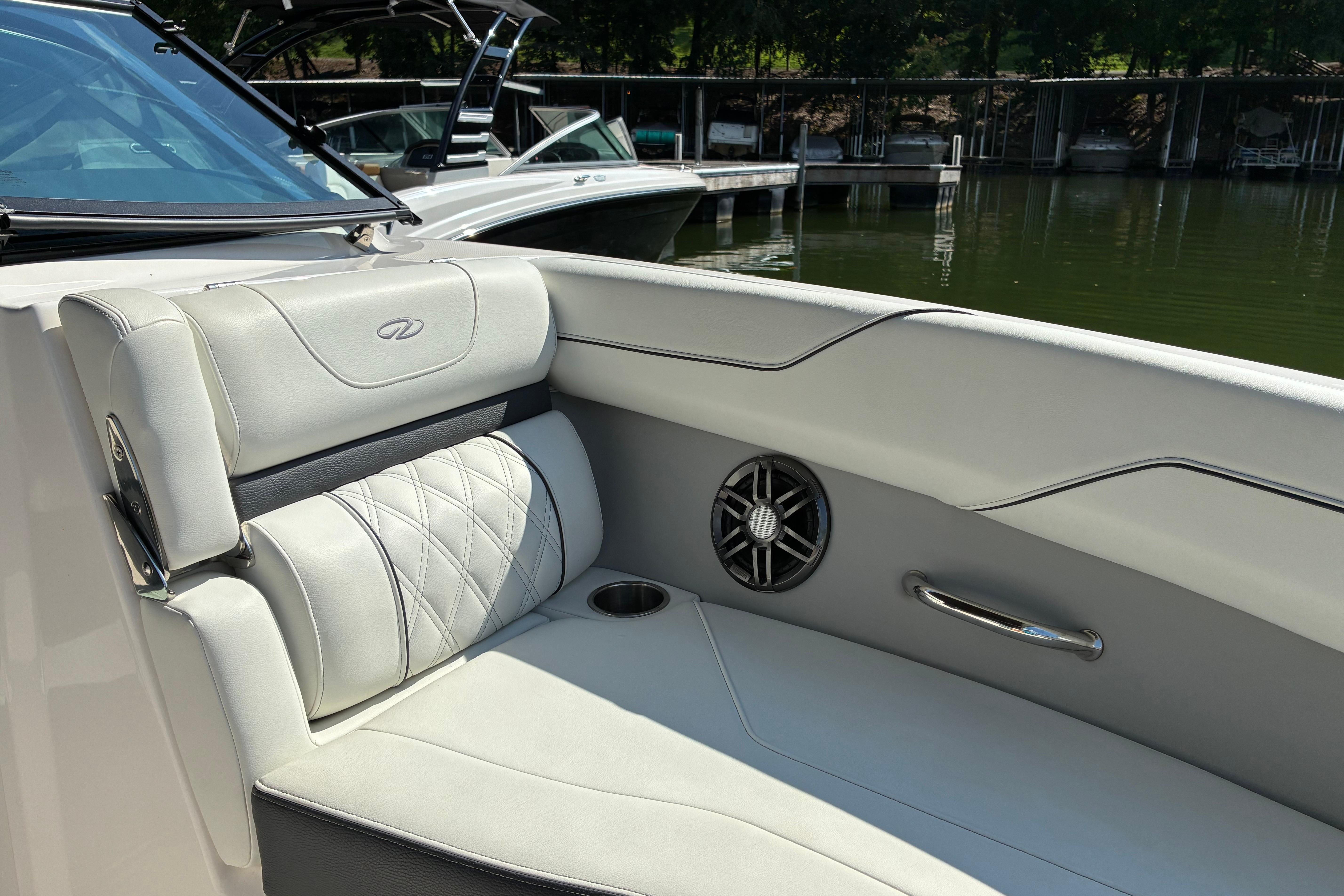2025 Regal LS2 boat interior with luxurious seating and speaker, docked by the water.