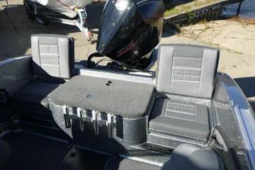 2026 Ranger 2080MS boat interior with seating and motor, dockside view.