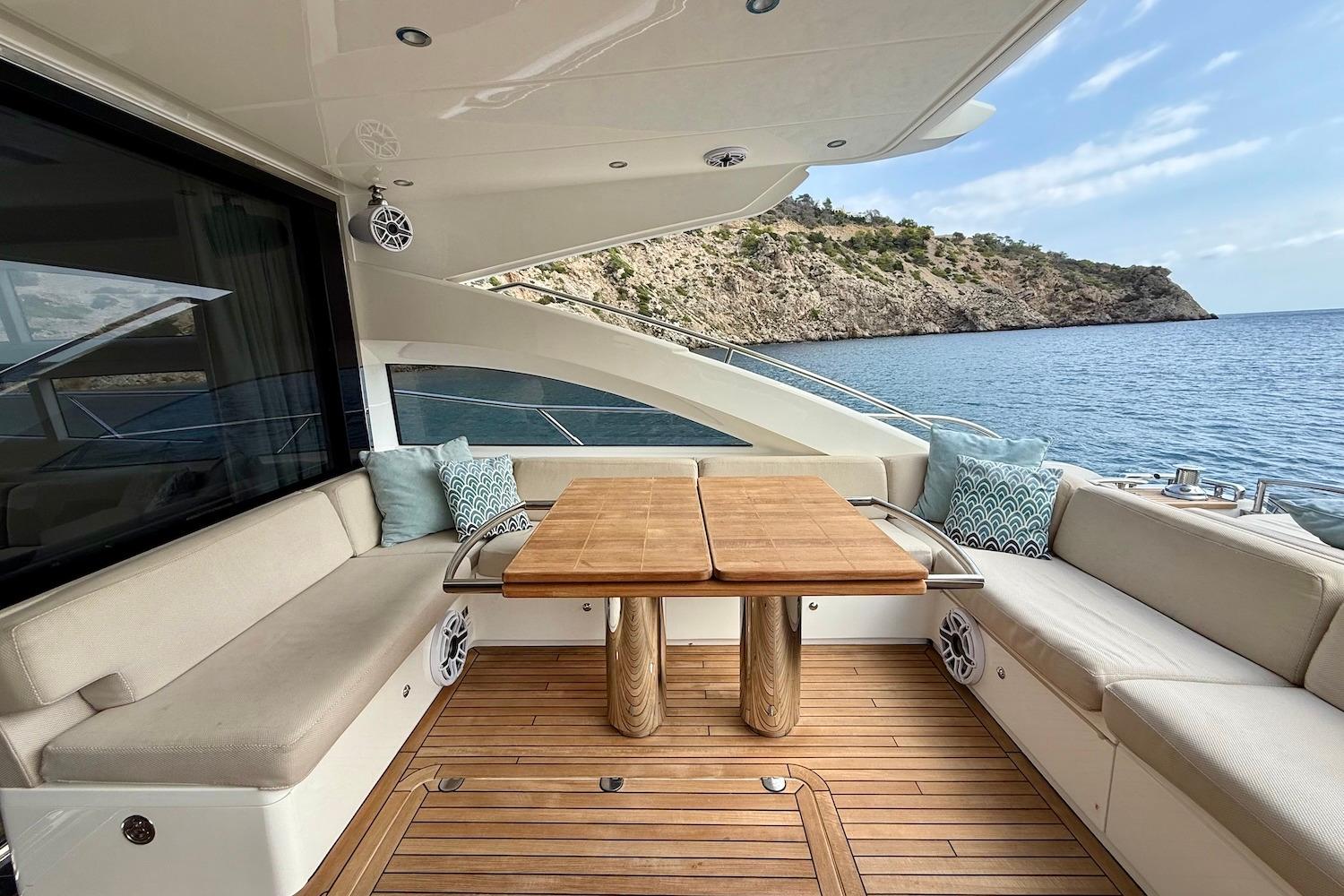 Luxurious 2015 Princess V72 yacht deck with elegant seating and scenic ocean view.
