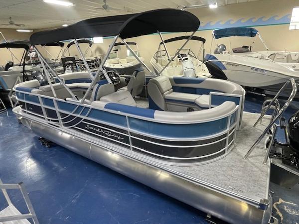 2025 South Bay LE pontoon boat with canopy in showroom.