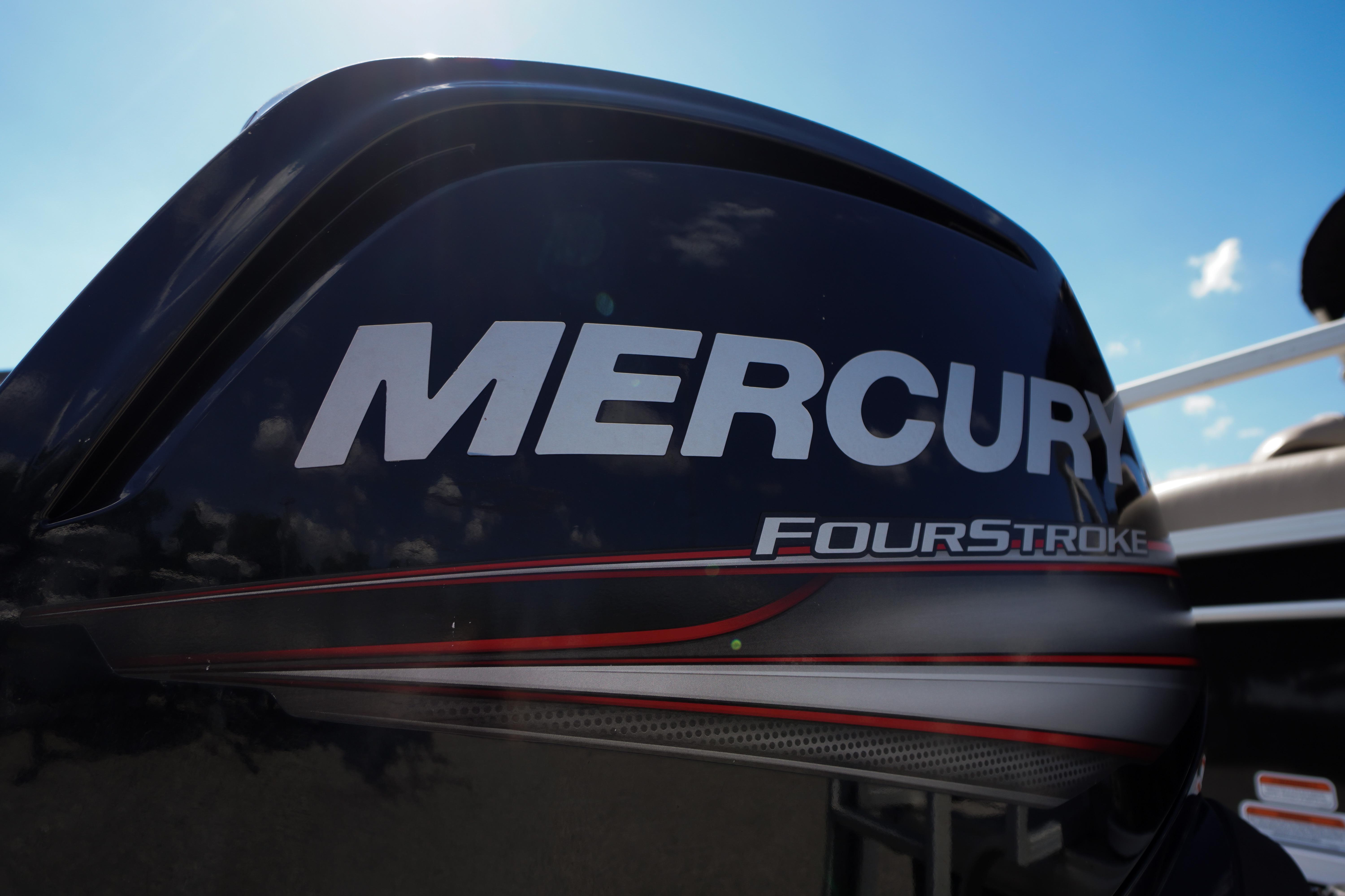 Mercury FourStroke engine on 2019 SUNTRACKER Fishin' Barge 22 DLX under blue sky.
