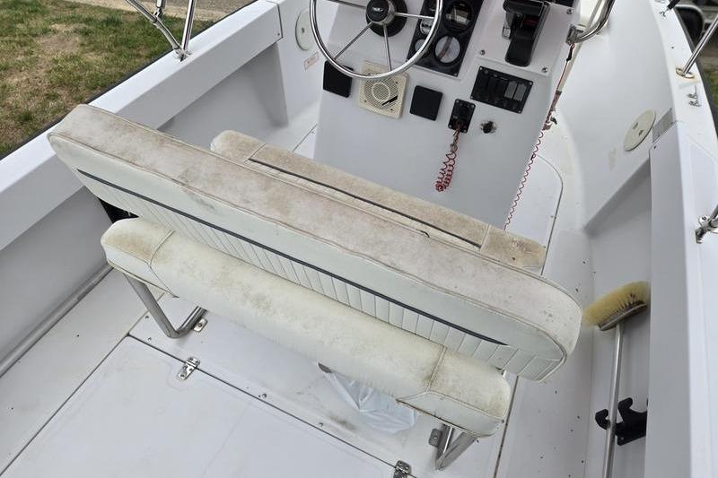 1996 Boston Whaler Outrage 17 boat interior with steering wheel and seating.