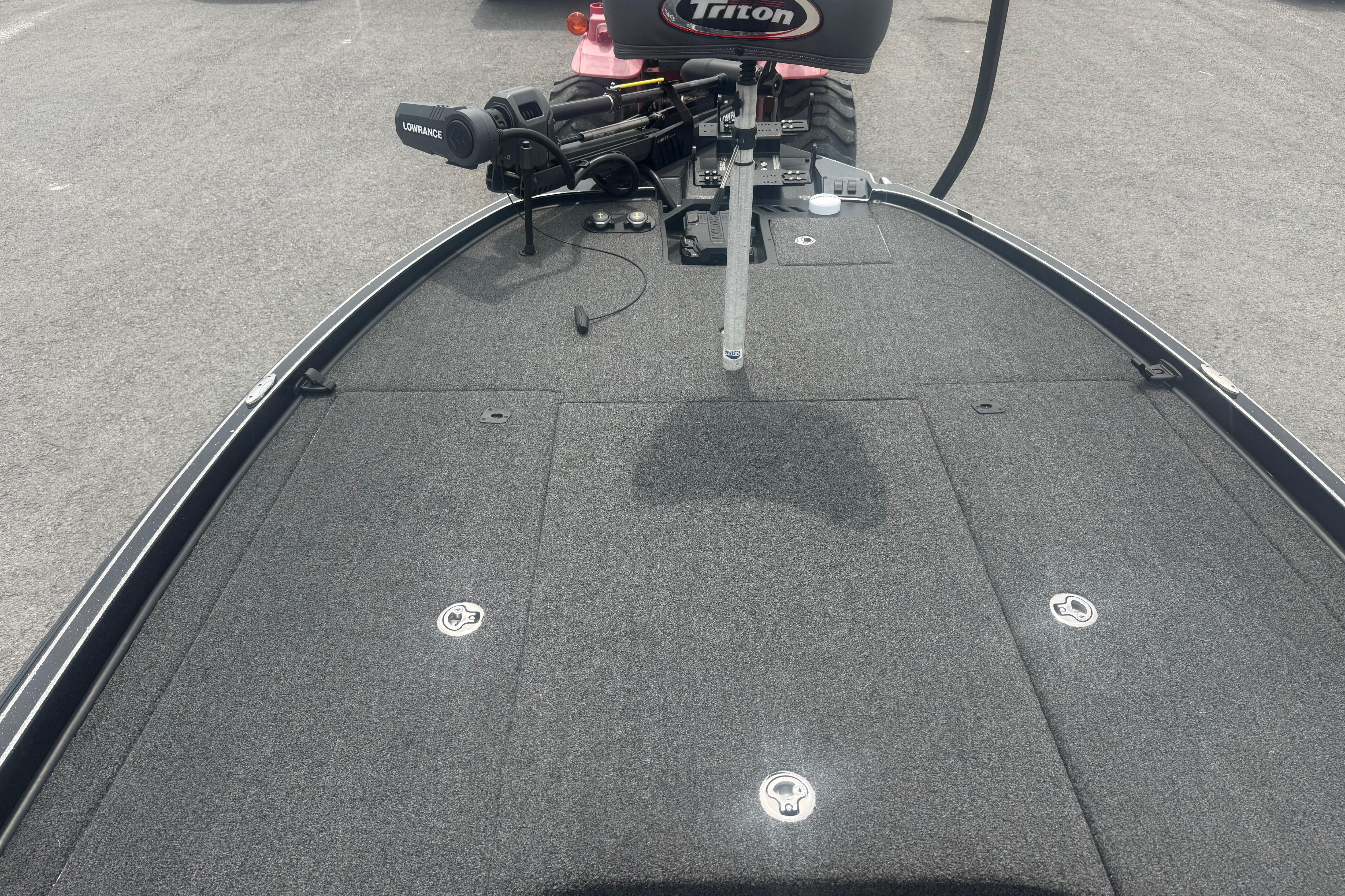 2024 Triton 20XP boat deck with Lowrance equipment, featuring a sleek, carpeted surface.