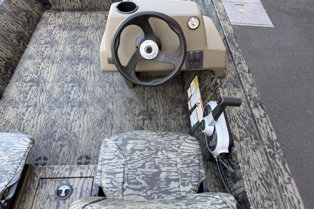 2026 Tracker Grizzly 1754 SC boat interior with camo design and steering console.
