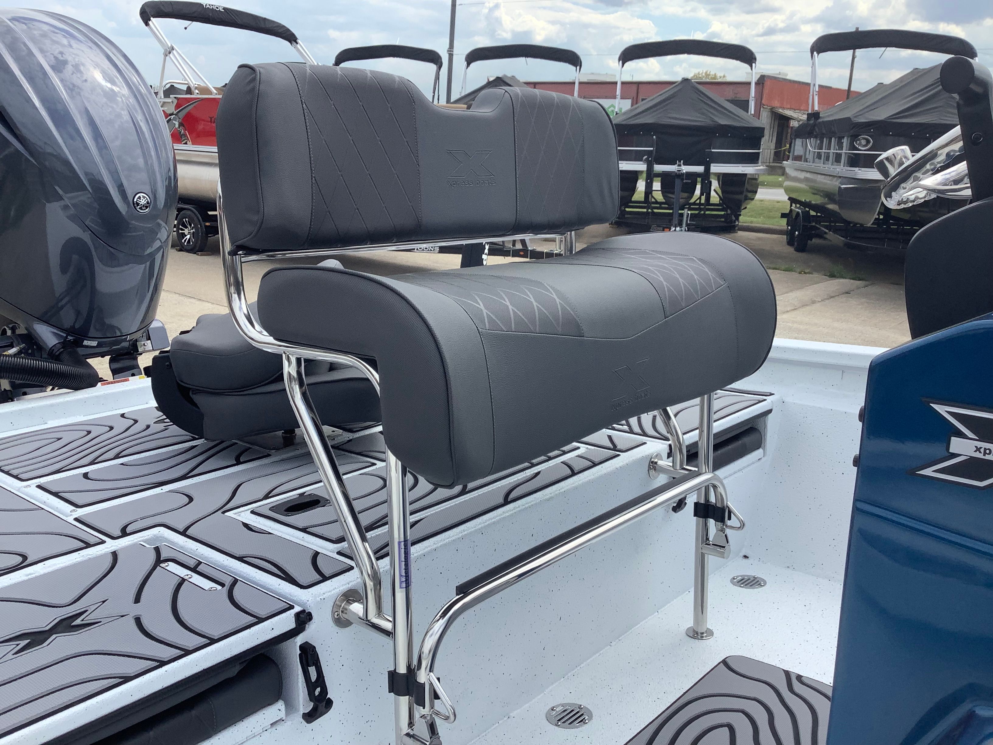 2026 Xpress H22B Bay boat with gray seats and stainless steel frame.