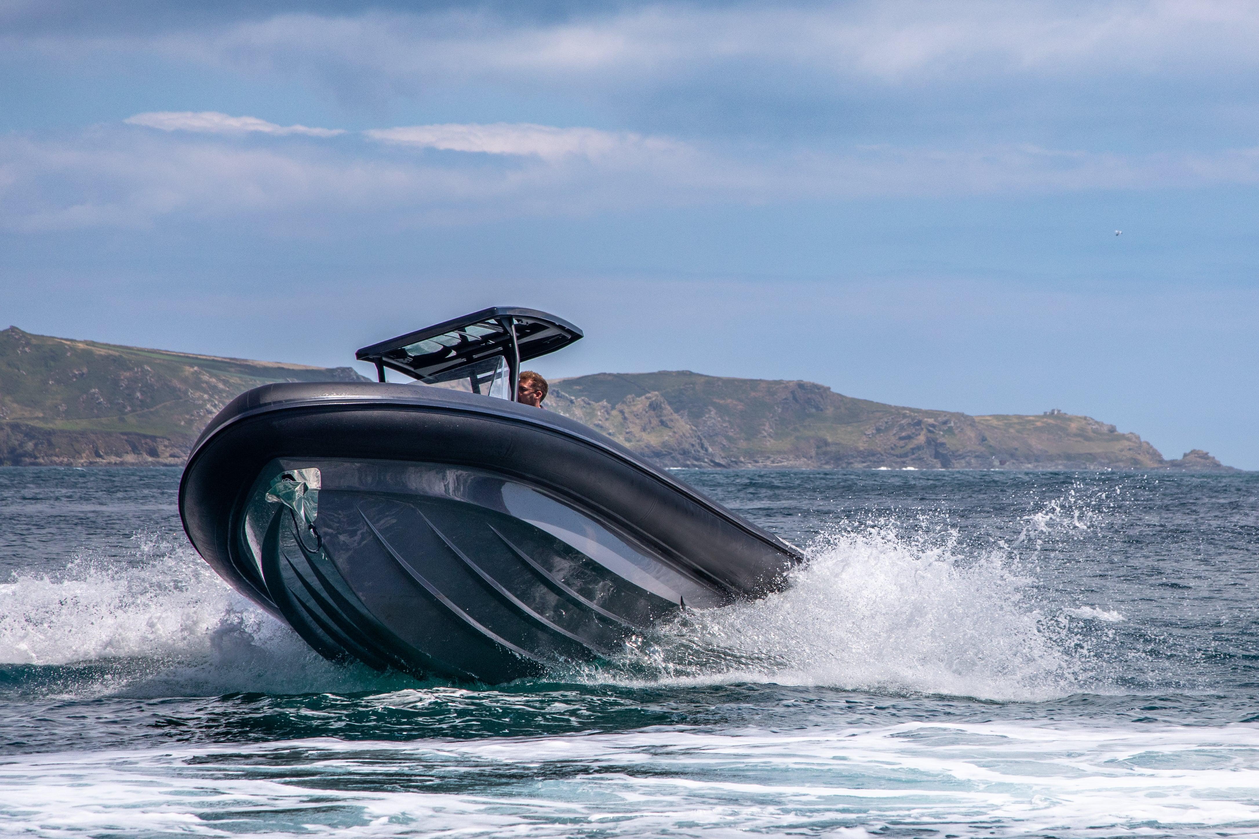 2024 Northstar Orion 8 boat navigating waves near rocky coastline.